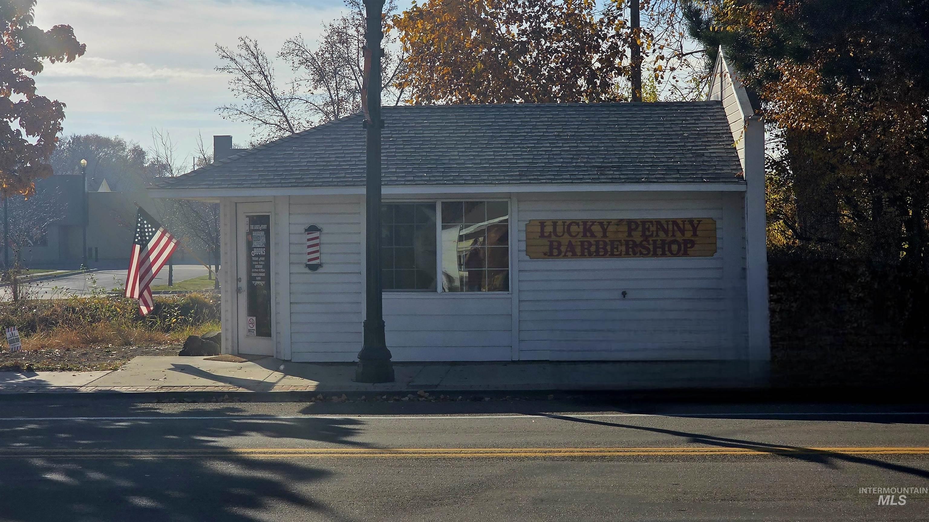 View of front of house with a chimney and an outbuilding
