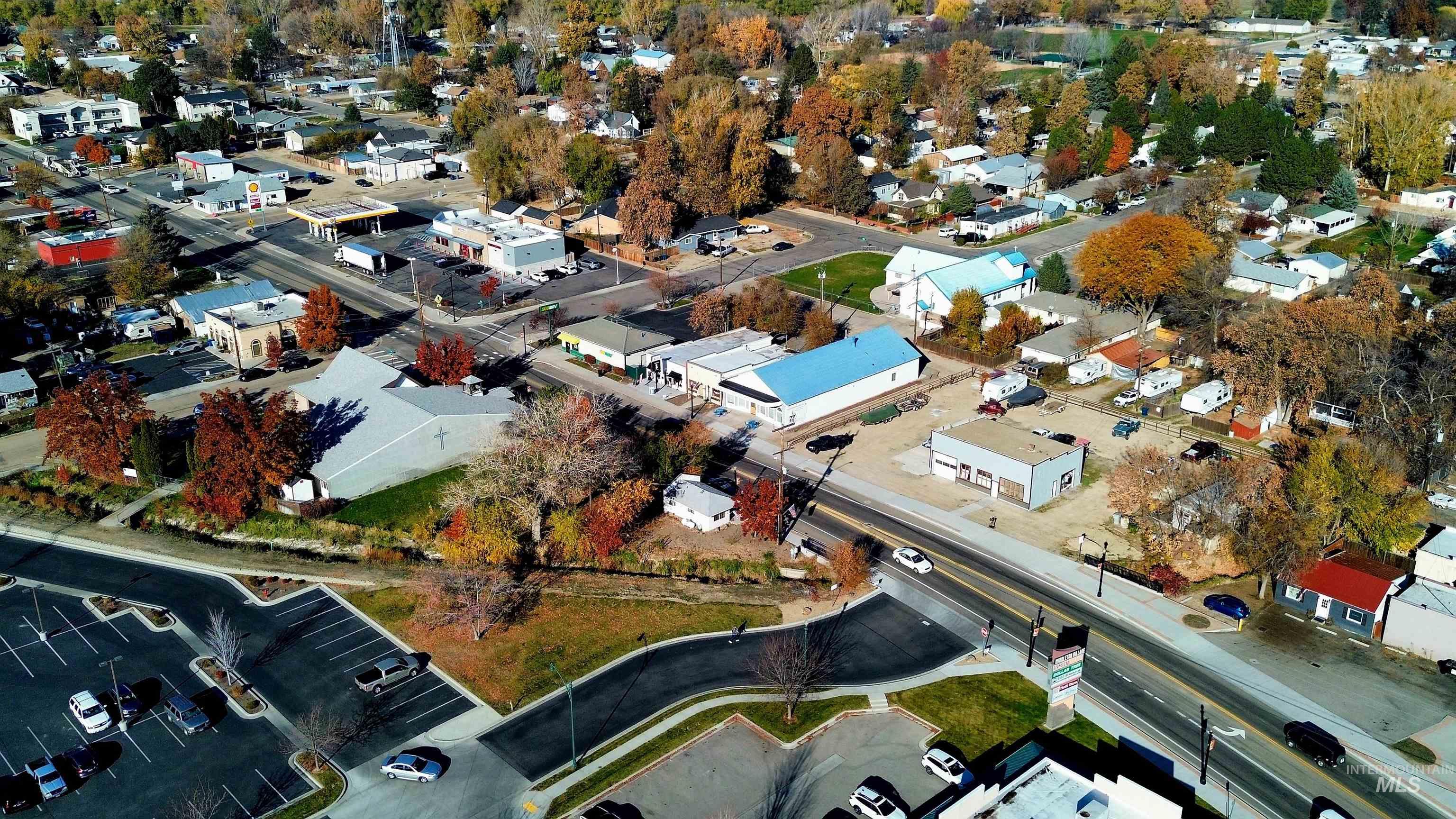 Aerial view of property and surrounding area featuring nearby suburban area