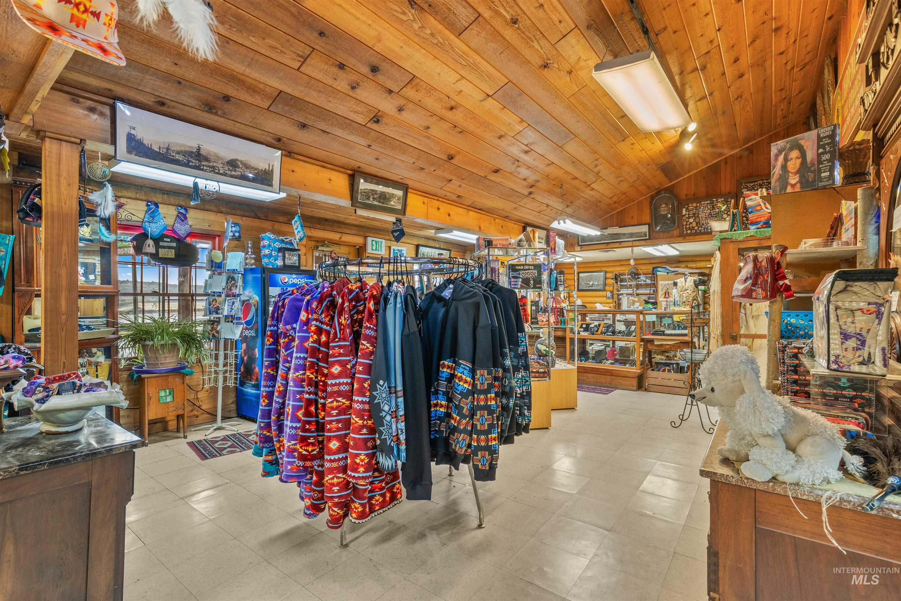 Miscellaneous room featuring lofted ceiling, wooden ceiling, wood walls, and light flooring