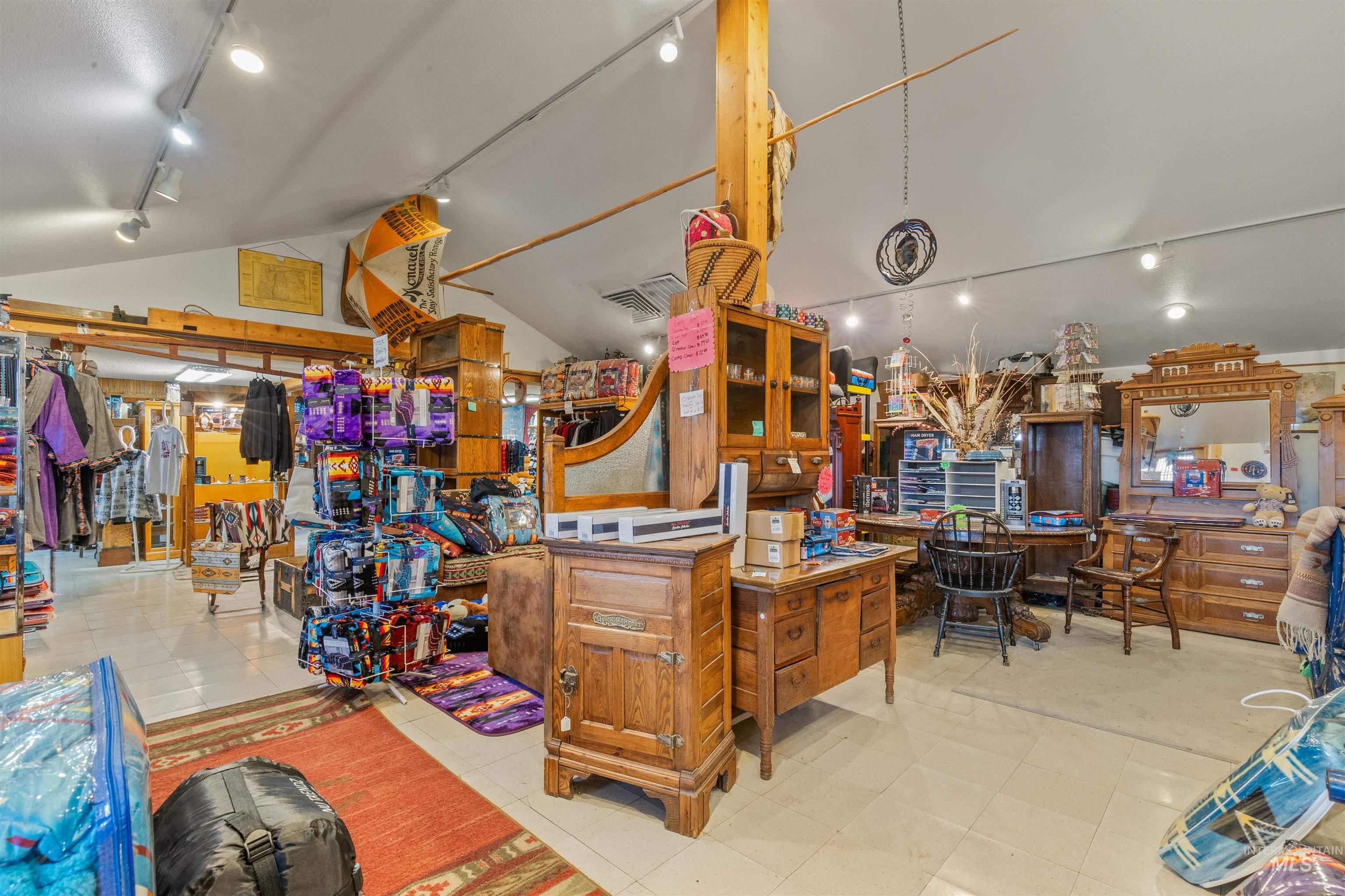 Misc room with track lighting, light tile patterned floors, and vaulted ceiling