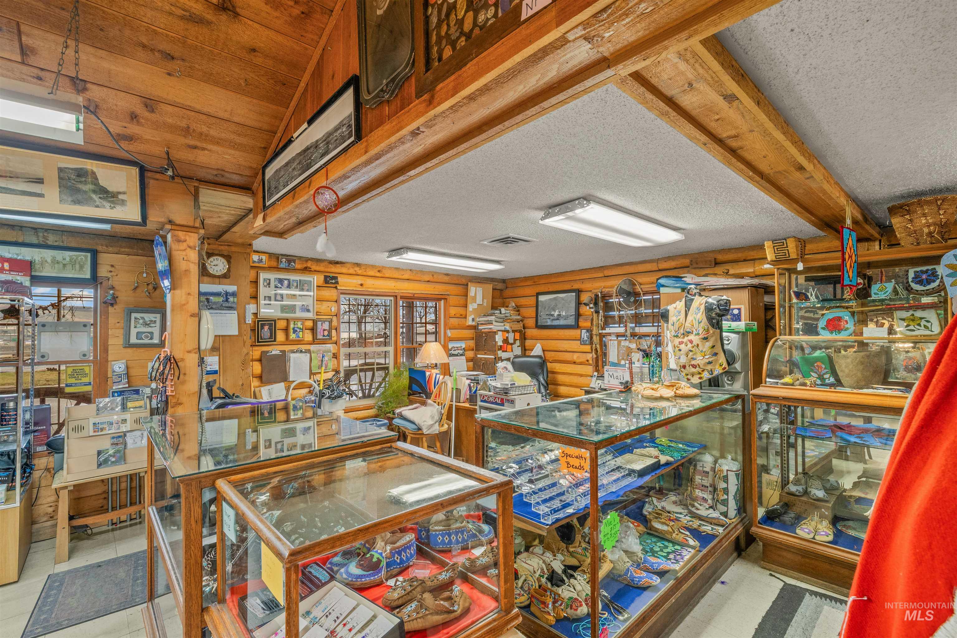 Misc room featuring a textured ceiling and log walls