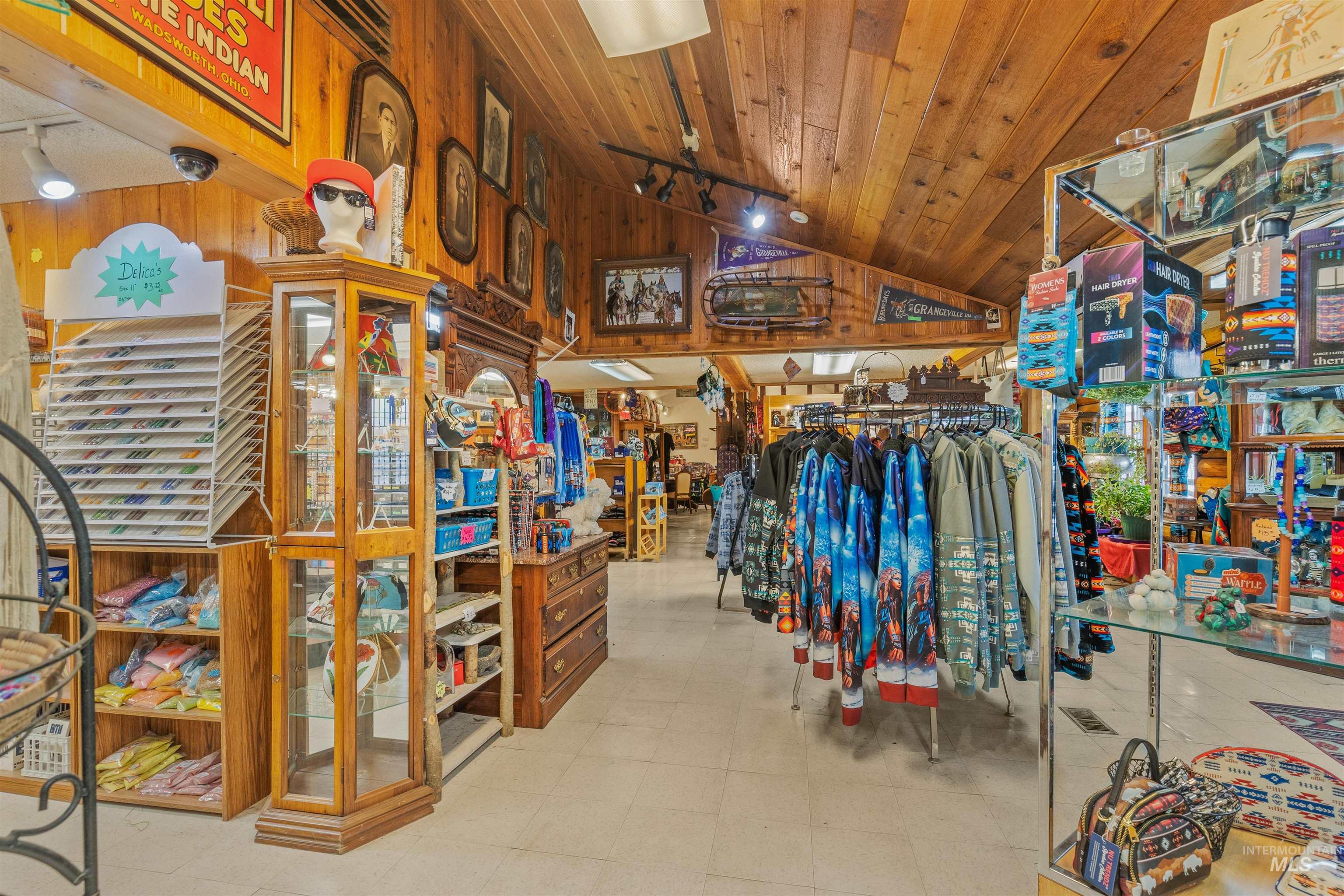 Miscellaneous room featuring track lighting, lofted ceiling, wooden ceiling, and wooden walls