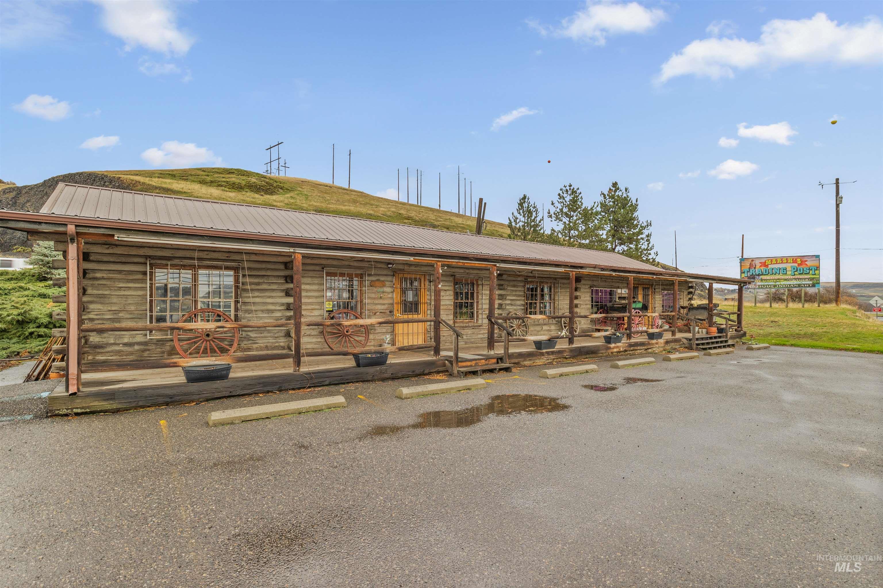View of building exterior with uncovered parking