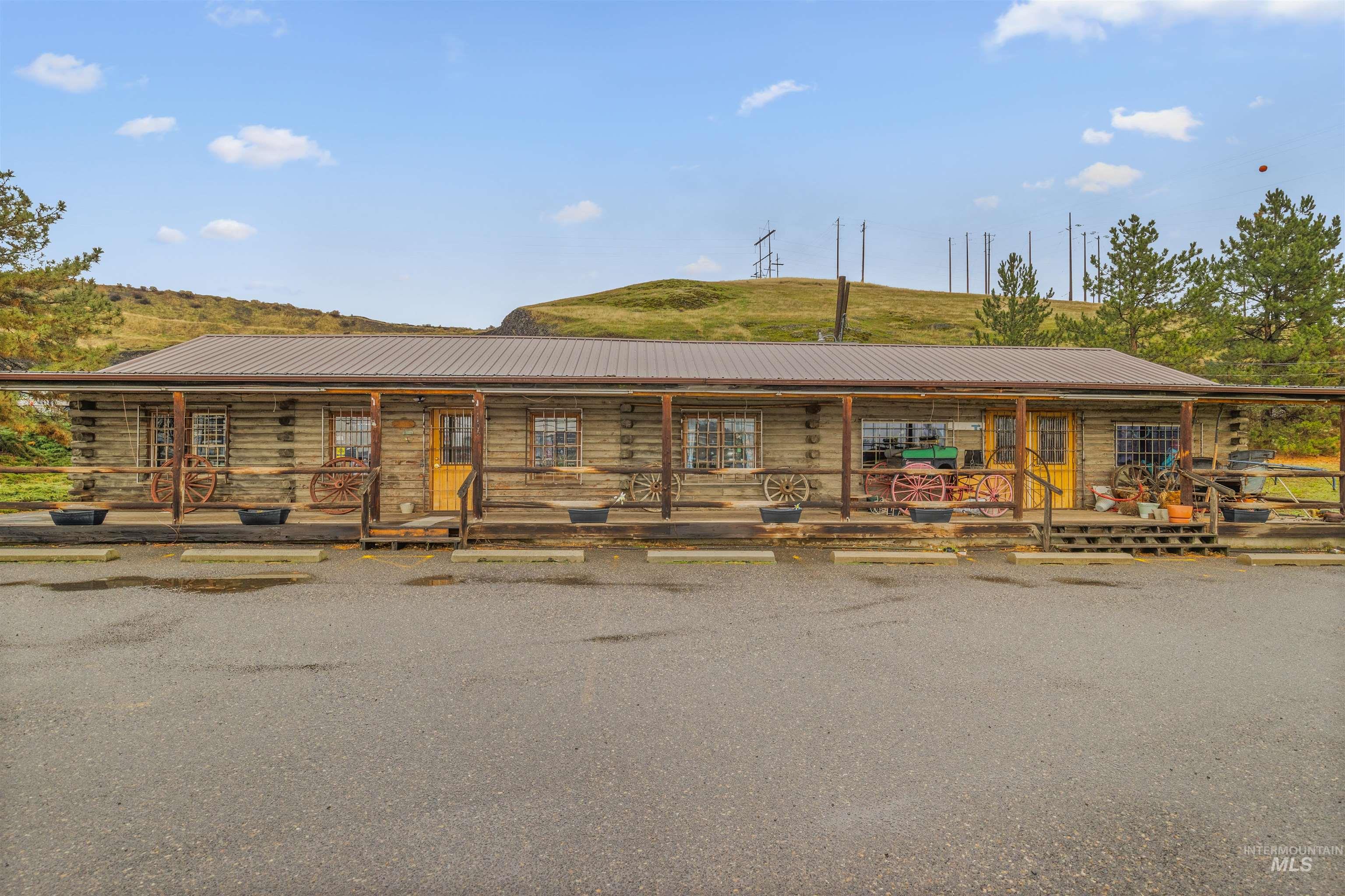 View of front of house with covered porch and a metal roof