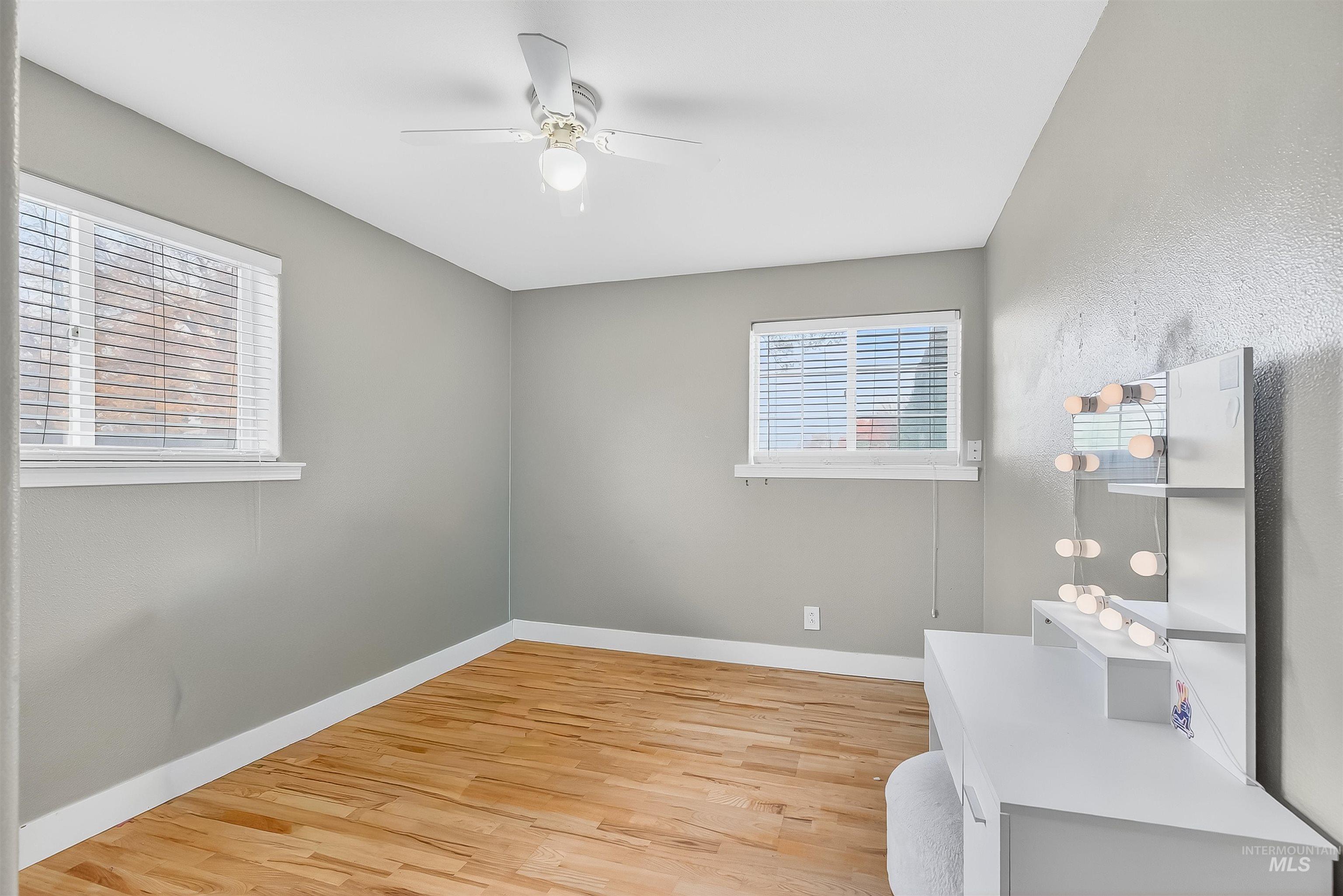 Unfurnished bedroom featuring light wood-style flooring and a ceiling fan