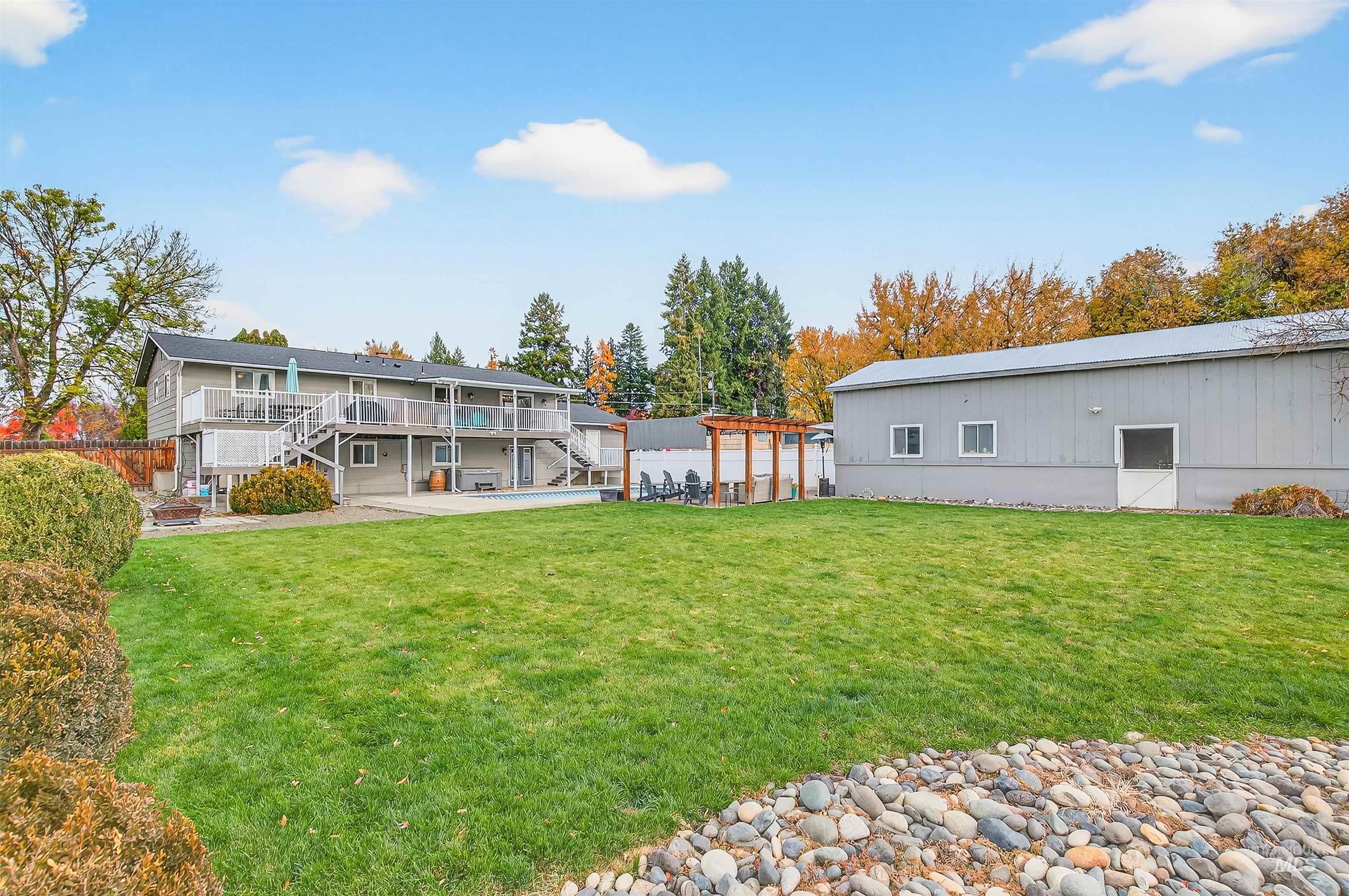 Rear view of property with a patio, stairway, and a wooden deck