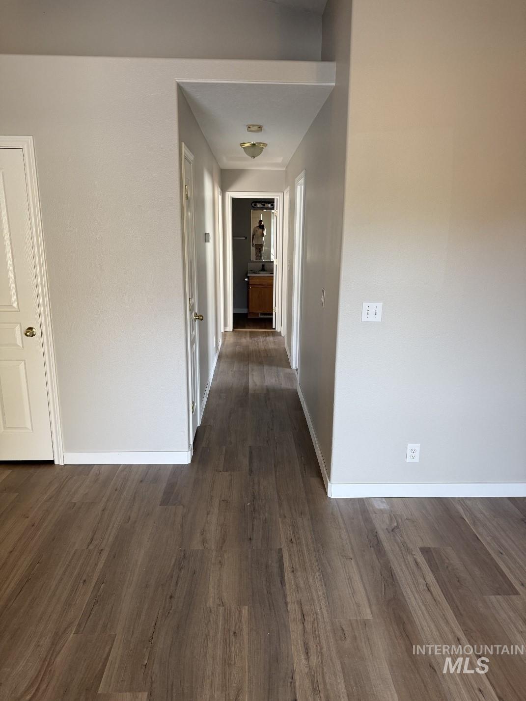 Hall featuring dark wood-style flooring