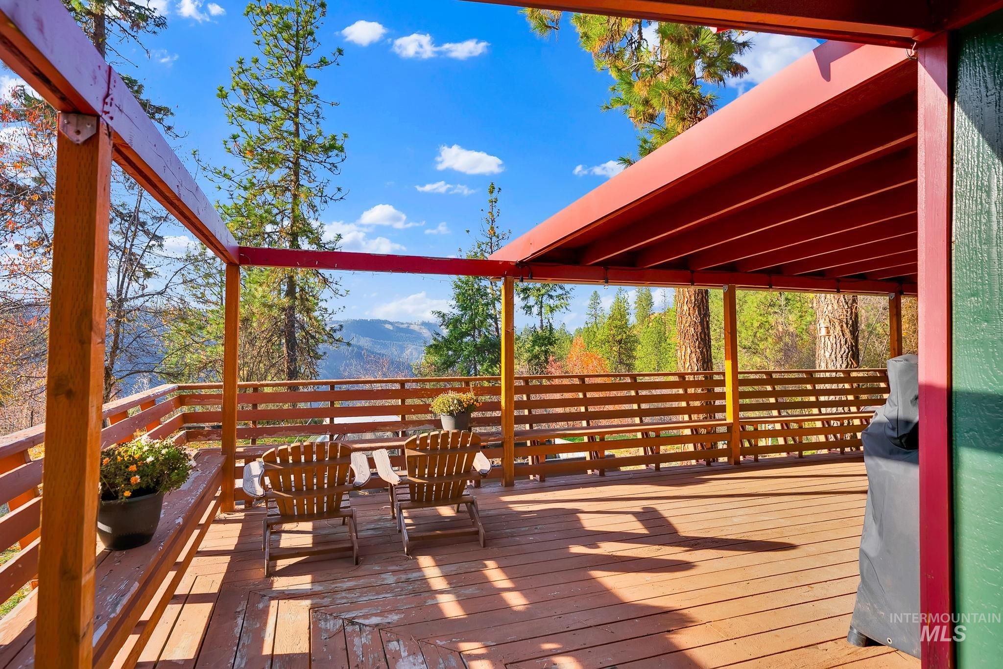 Wooden terrace with a mountain view and a grill