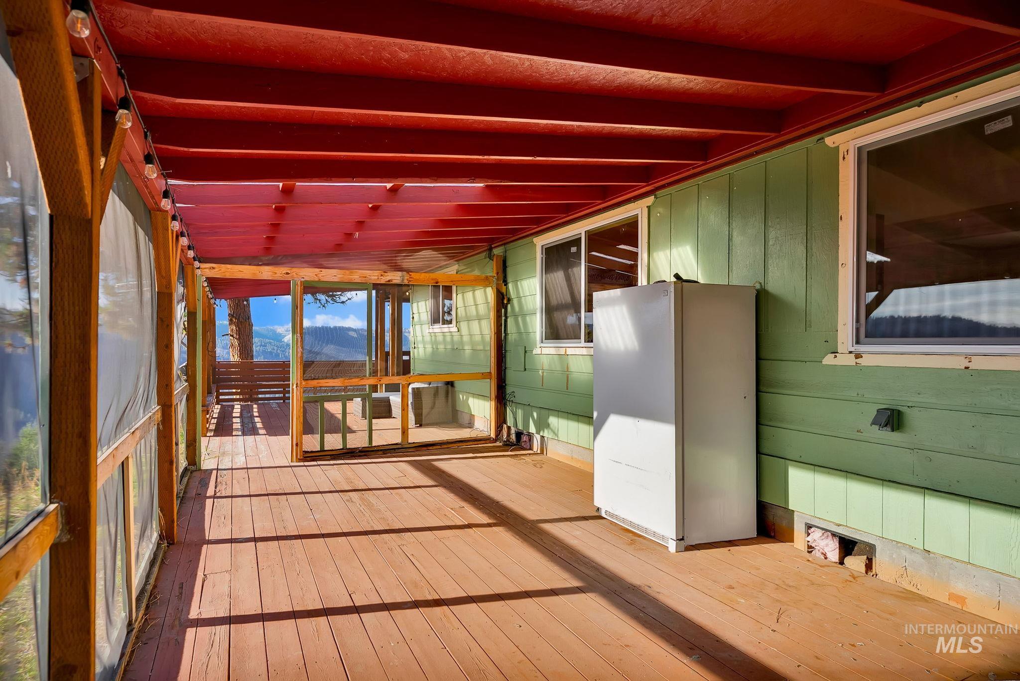 Unfurnished sunroom with a deck