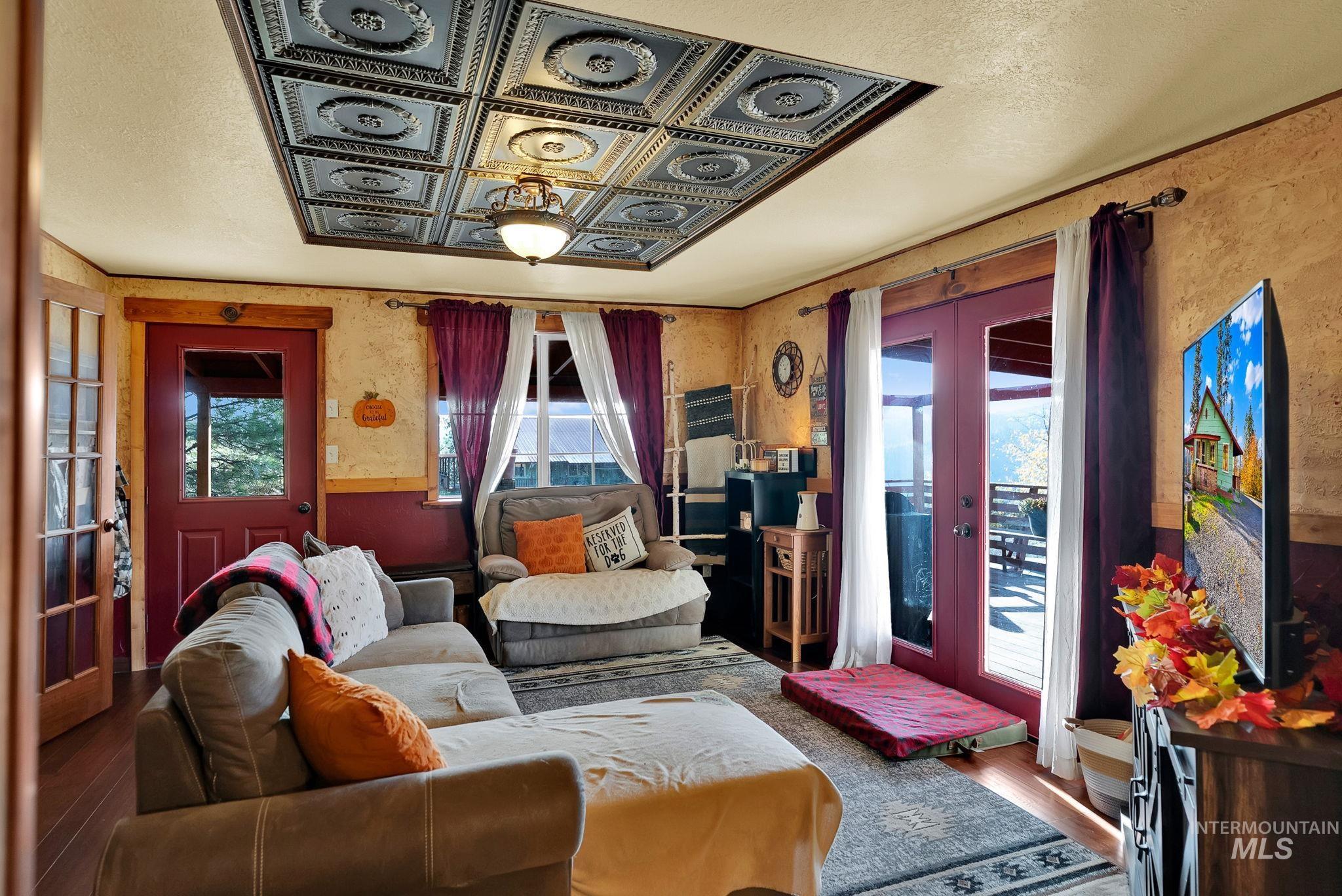Living room featuring french doors, wood finished floors, and a textured ceiling
