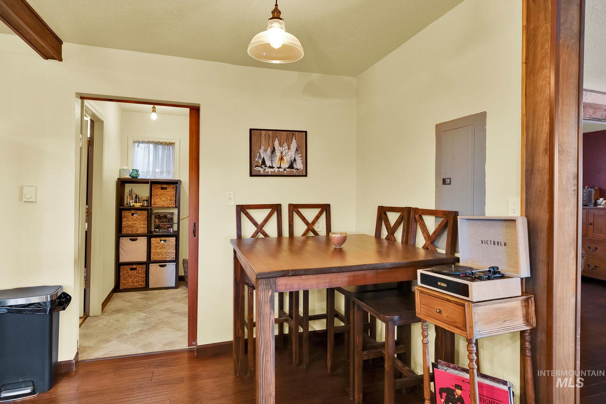 Dining space featuring wood finished floors and electric panel