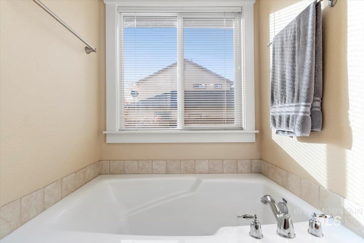 Full bath with plenty of natural light and a bath