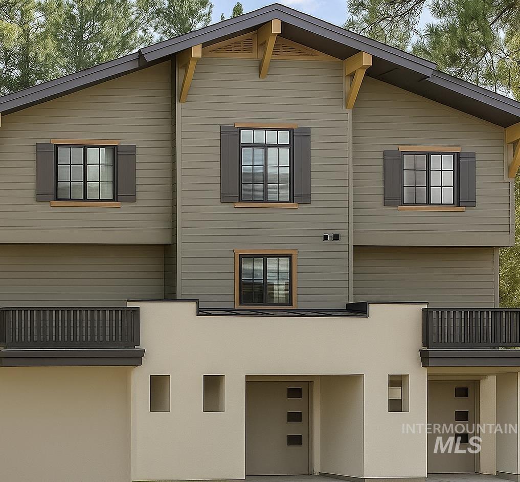 Back of house featuring stucco siding, a patio, and a balcony