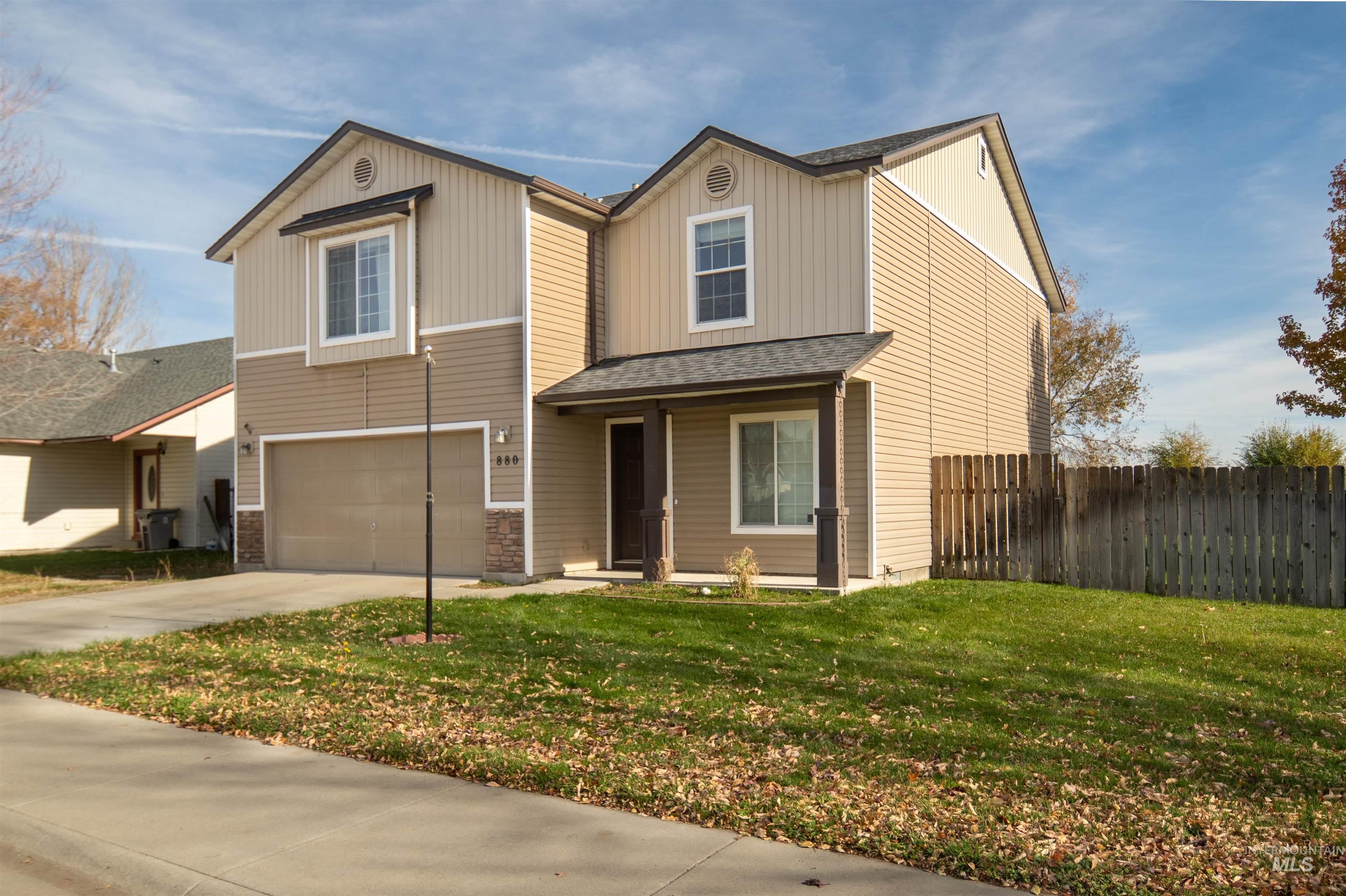 View of front of property with a shingled roof, concrete driveway, and an attached garage