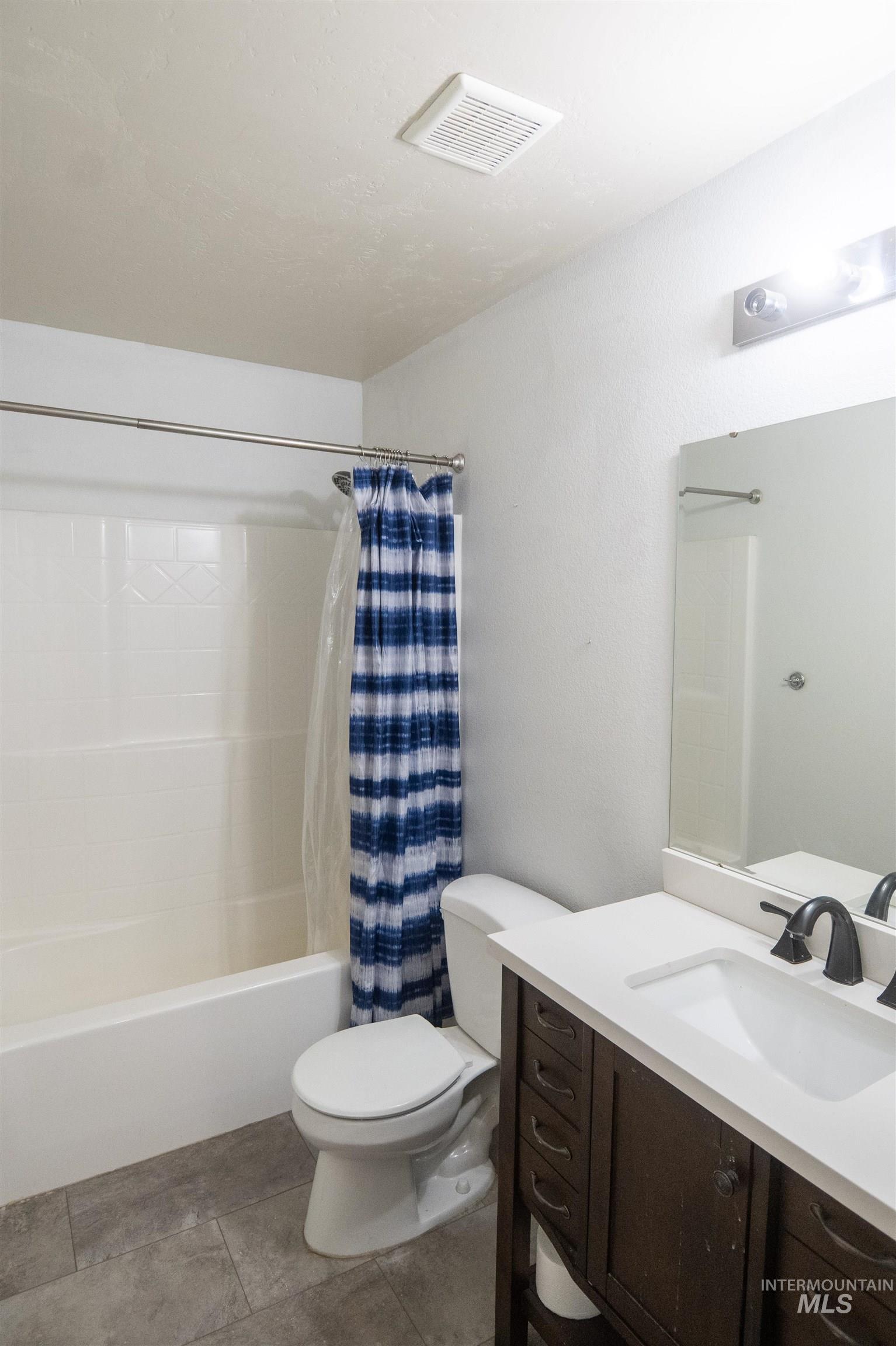 Bathroom featuring shower / bath combo and vanity