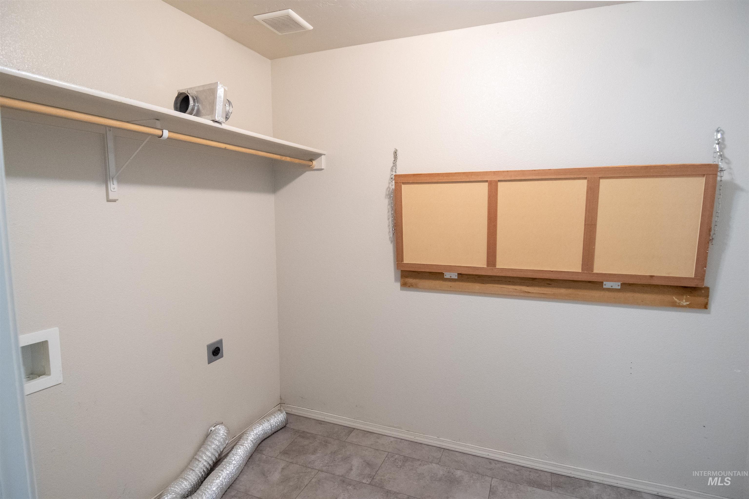 Laundry area featuring hookup for a washing machine, electric dryer hookup, and tile patterned flooring