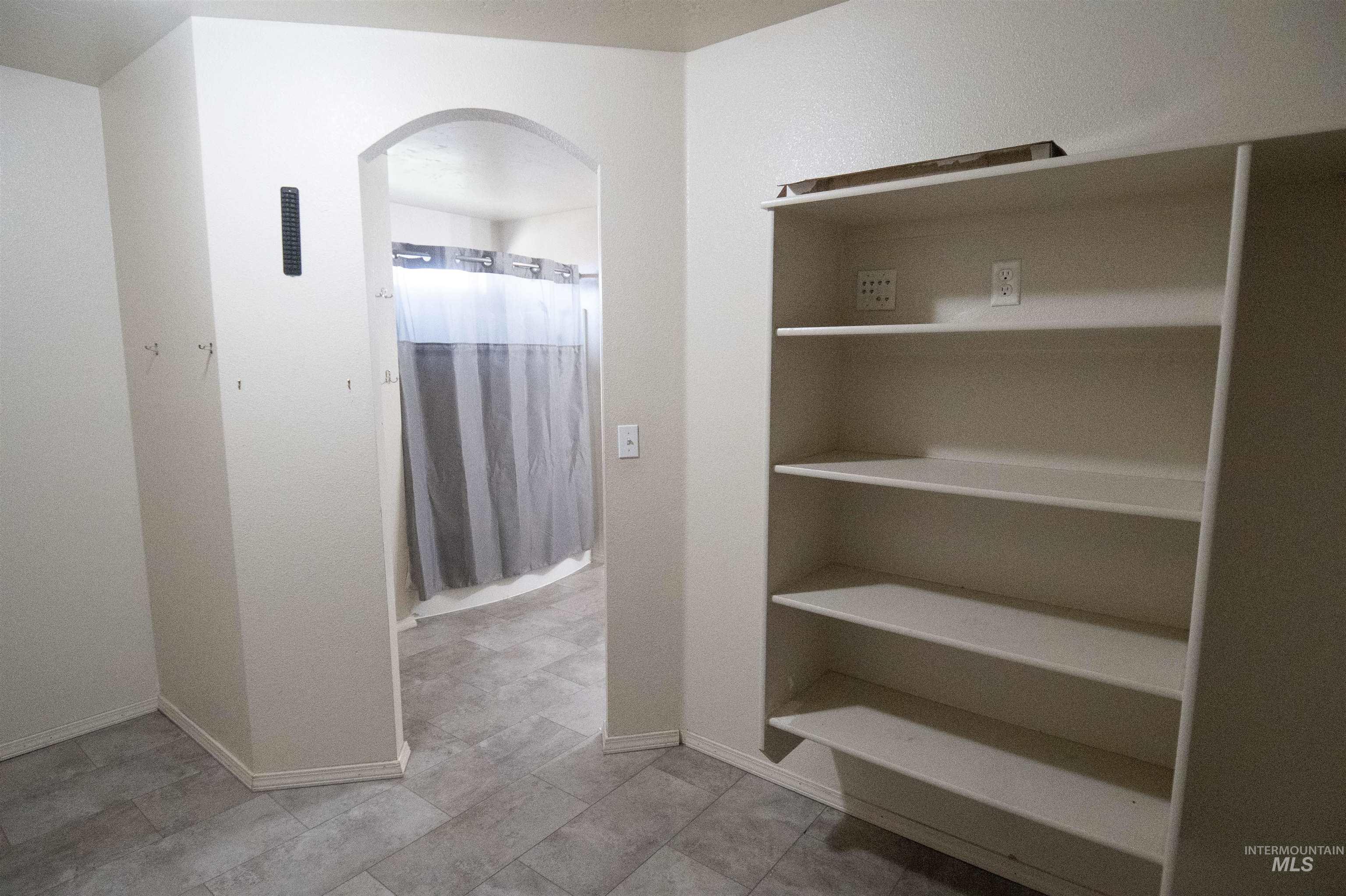 Bathroom with baseboards and a shower with shower curtain