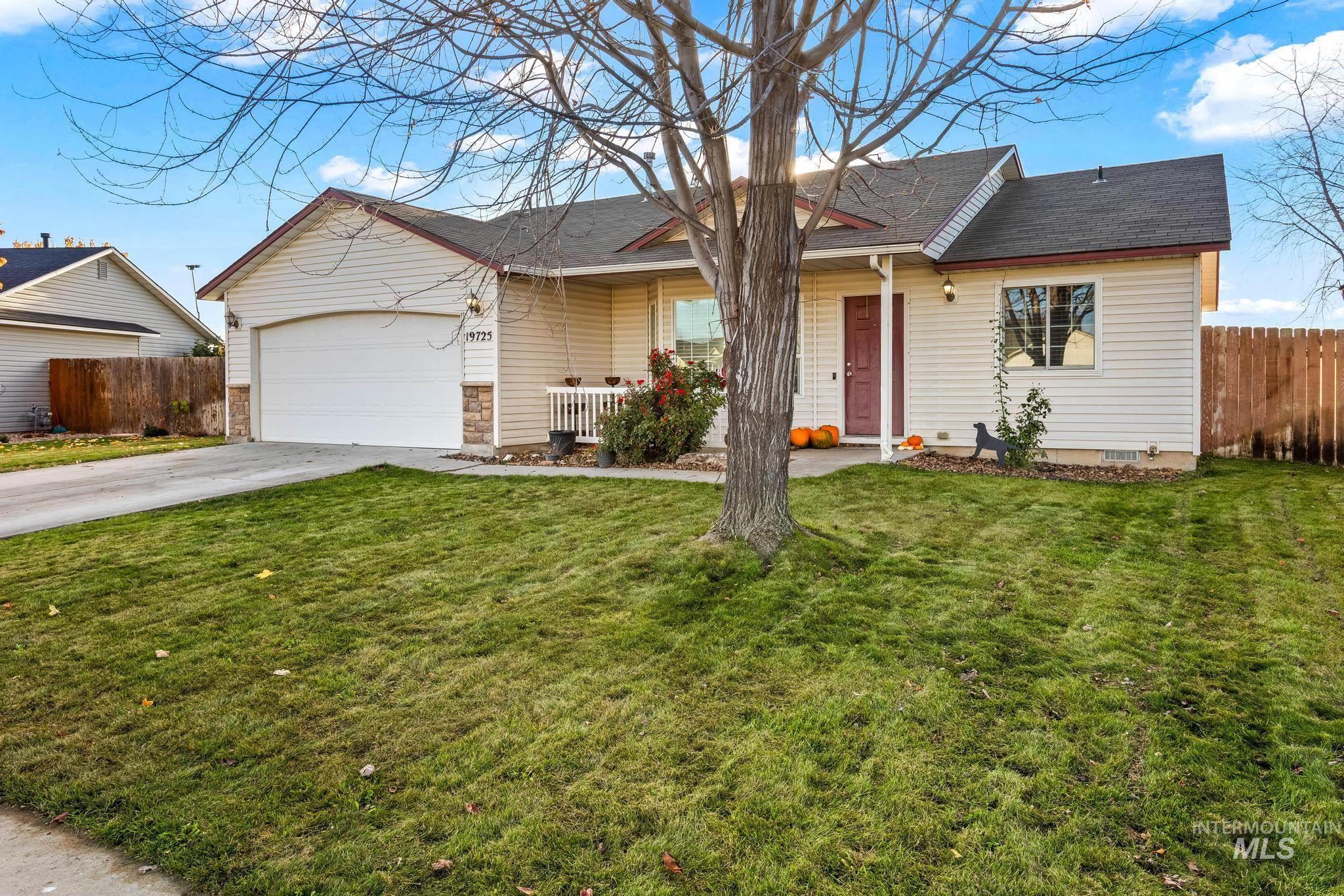 Ranch-style home with driveway, a shingled roof, a porch, and a garage