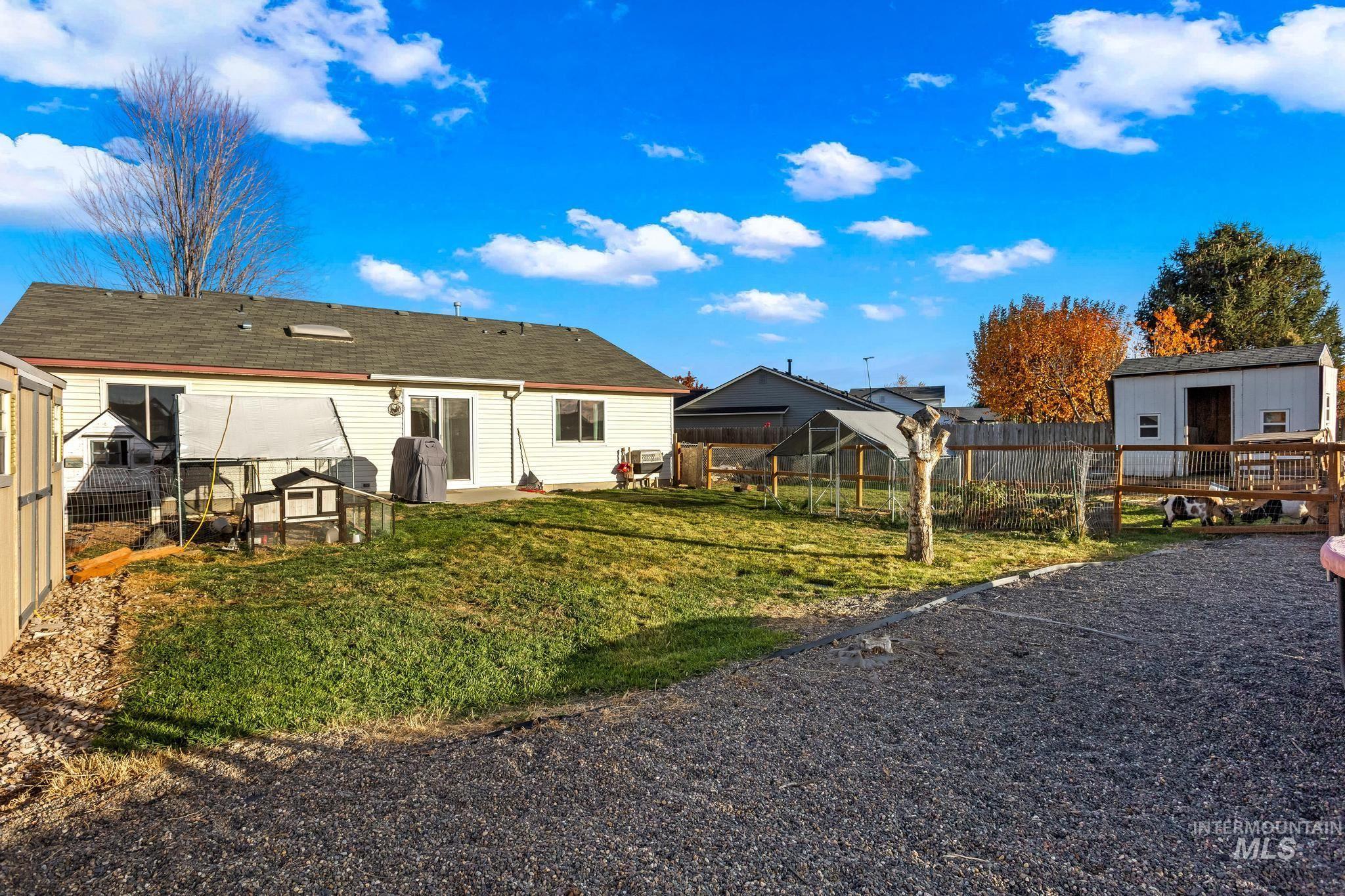 Rear view of property featuring an outbuilding and a patio area
