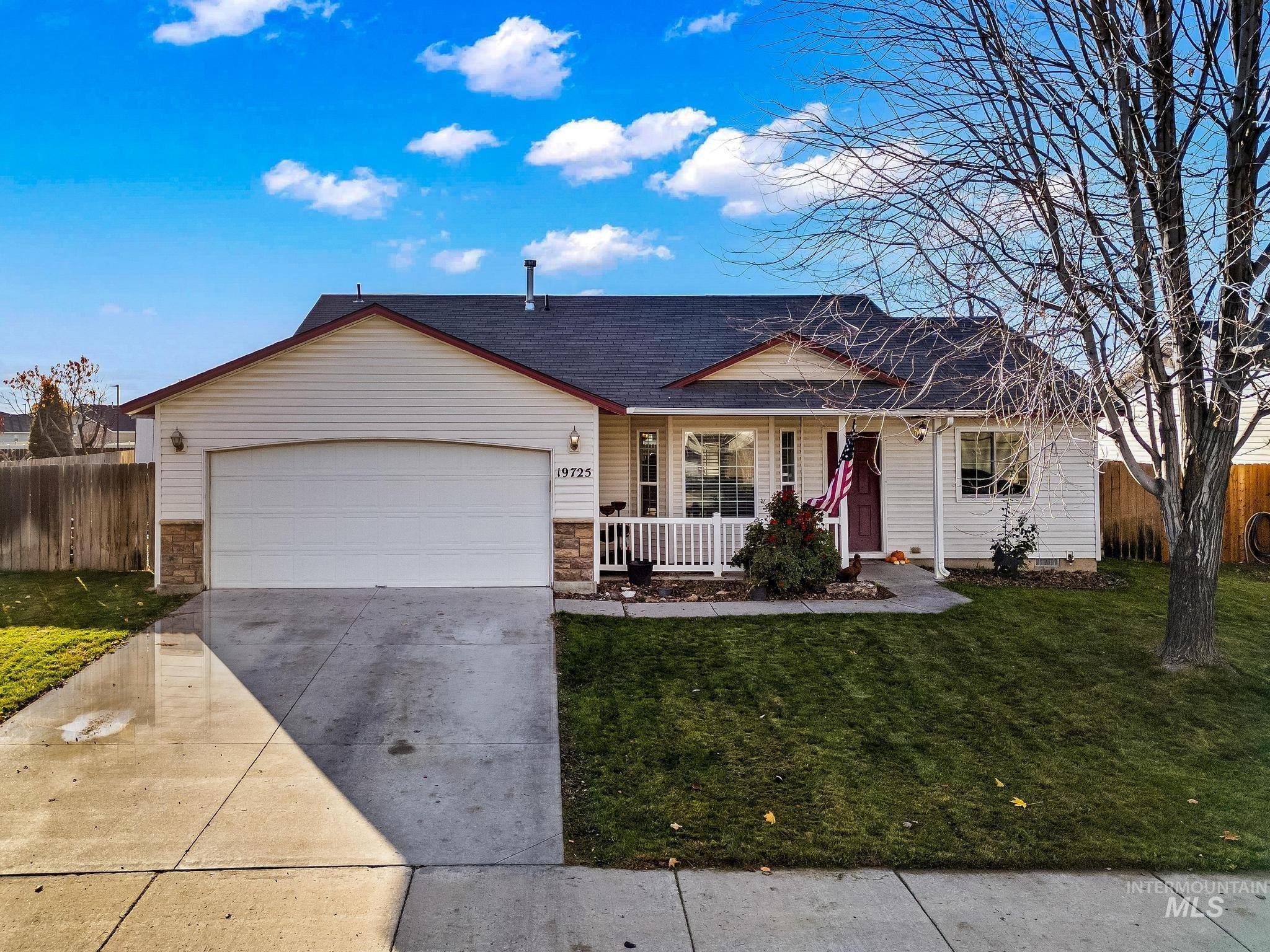 Ranch-style house with covered porch, driveway, an attached garage, and a shingled roof