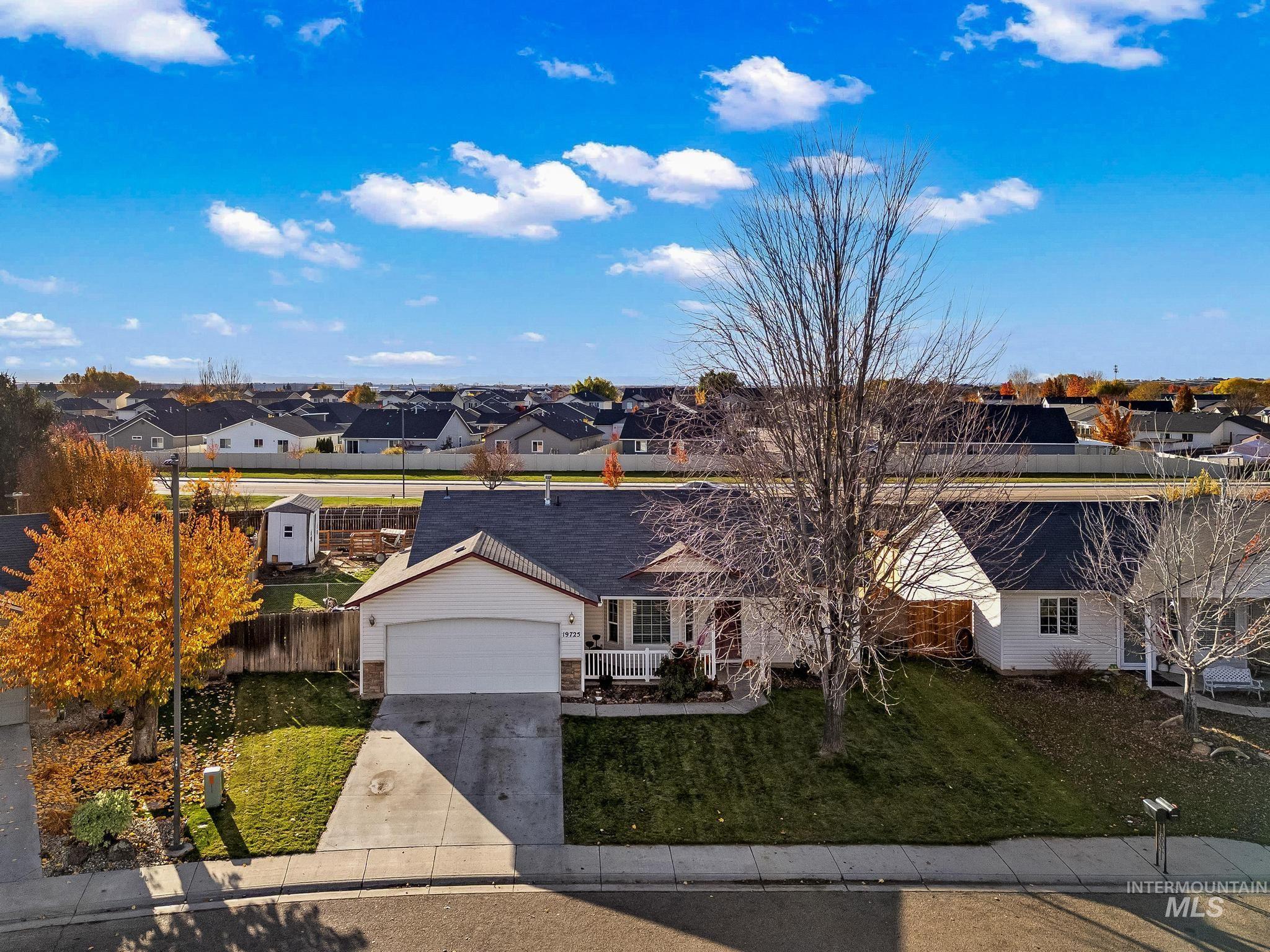 Ranch-style house with a residential view, concrete driveway, and a garage