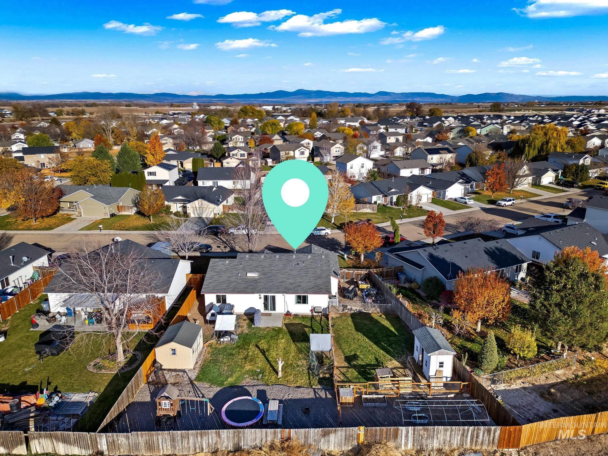 Aerial perspective of suburban area featuring a mountain backdrop
