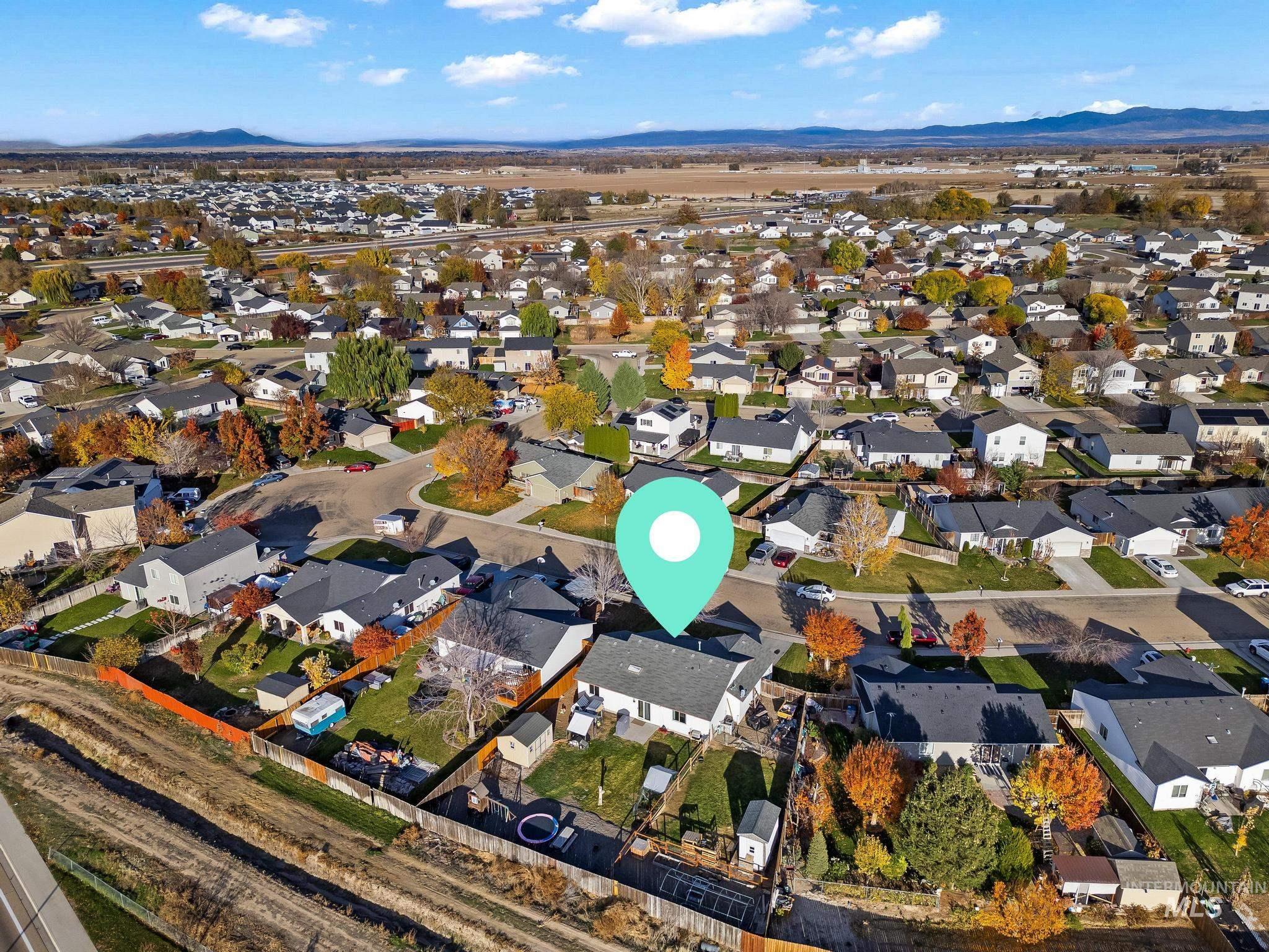 Aerial view of property's location featuring nearby suburban area