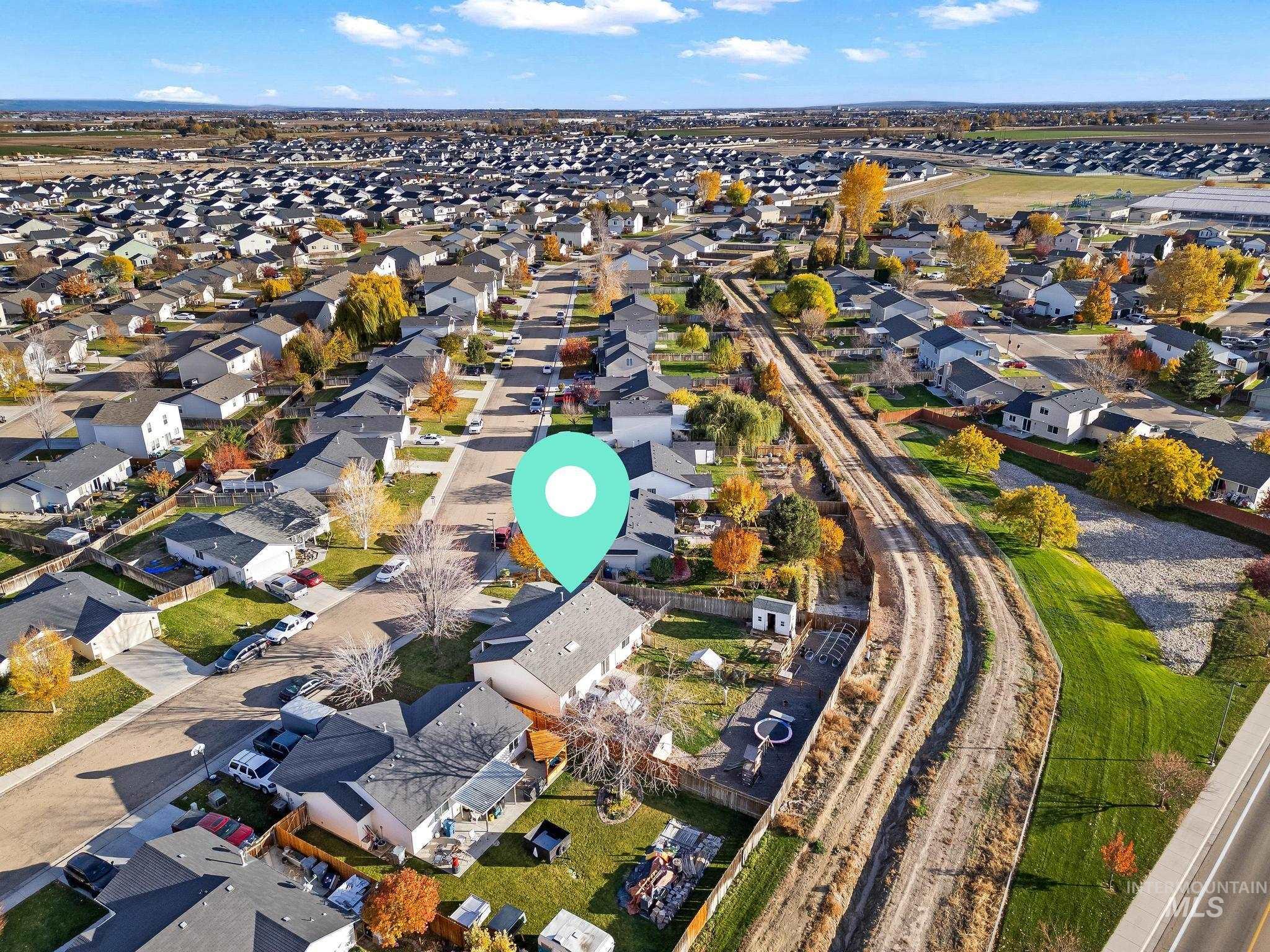 Aerial overview of property's location featuring nearby suburban area
