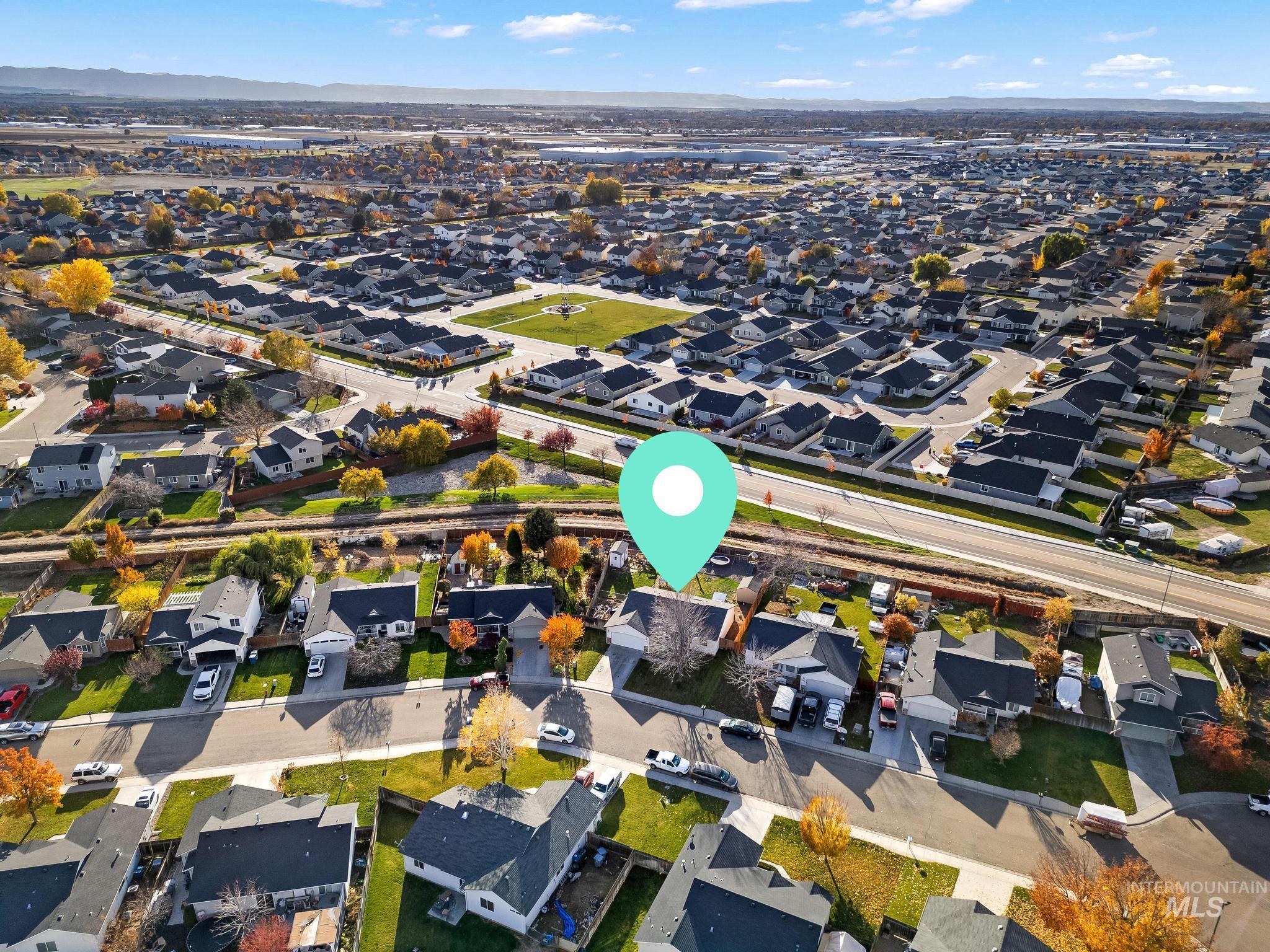 Aerial view of property's location with nearby suburban area