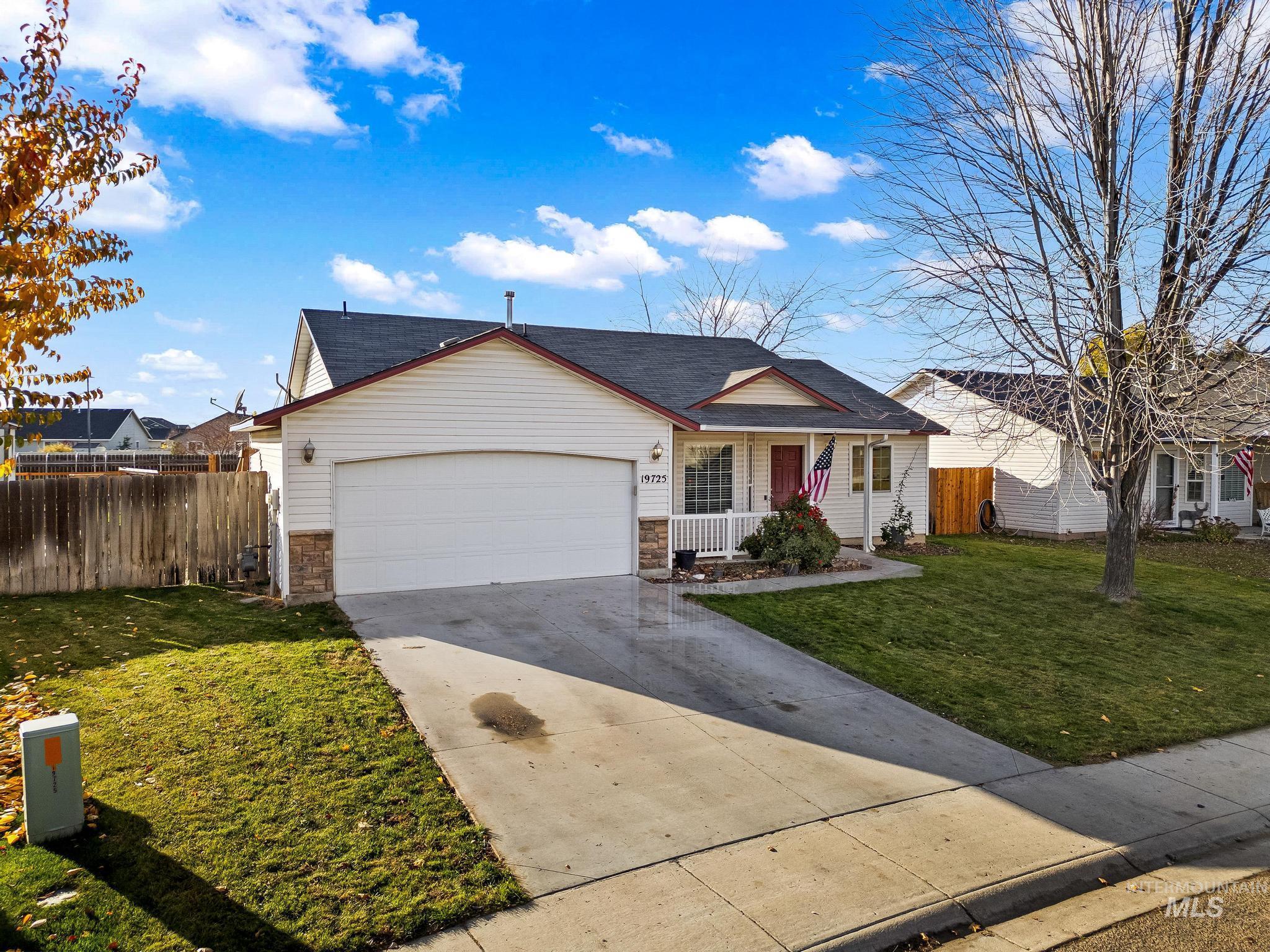 View of front of home featuring a porch, driveway, and an attached garage