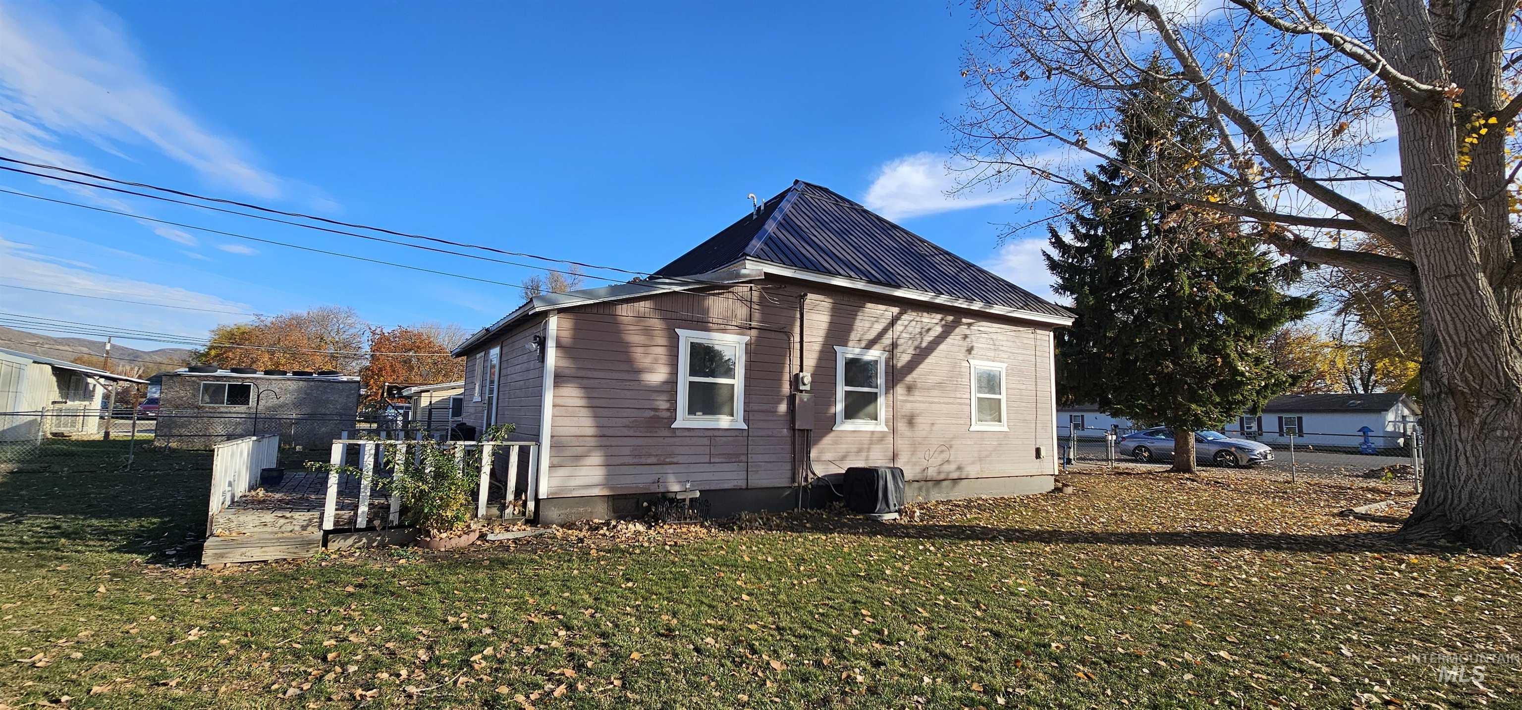 View of side of home featuring a metal roof