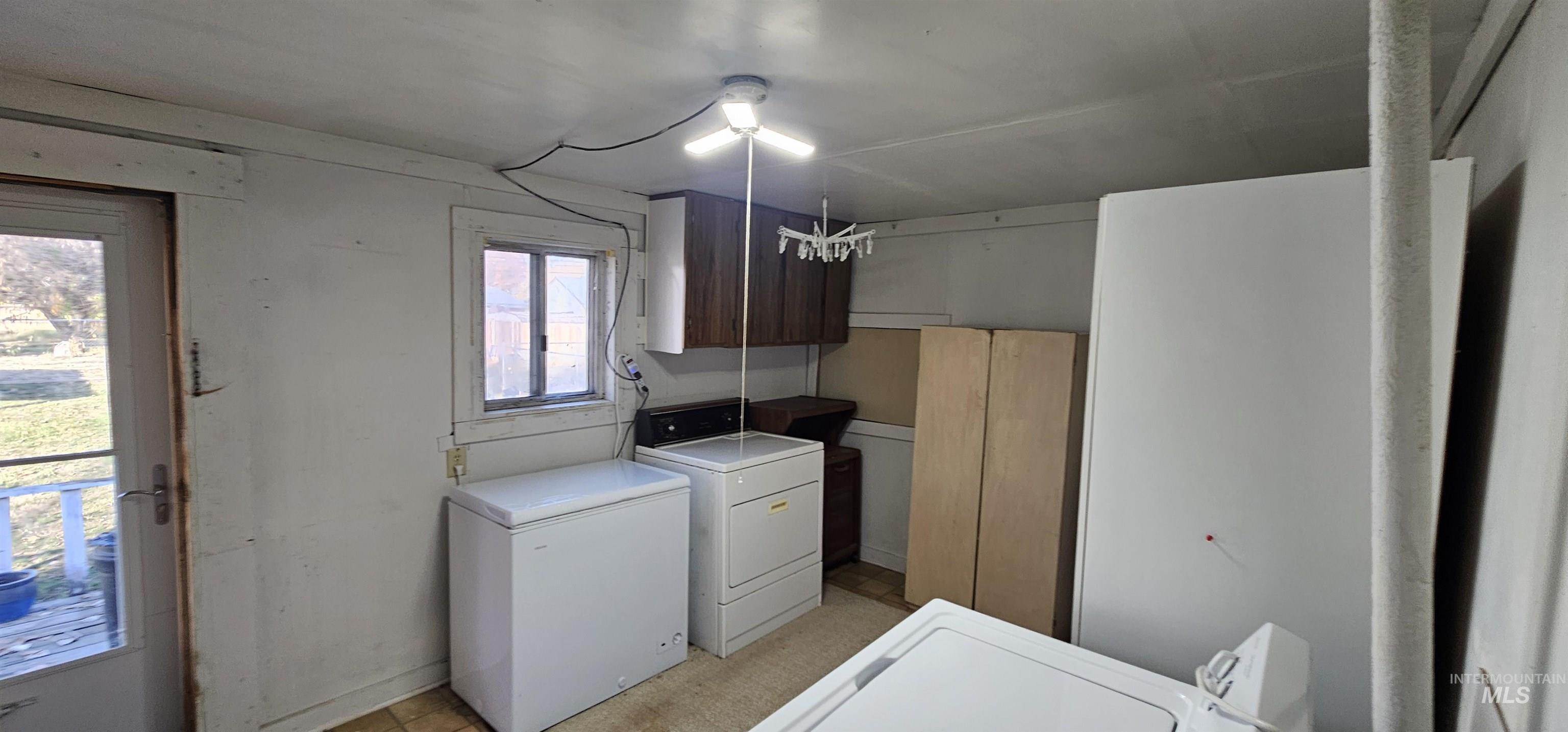Washroom with washer and dryer and cabinet space