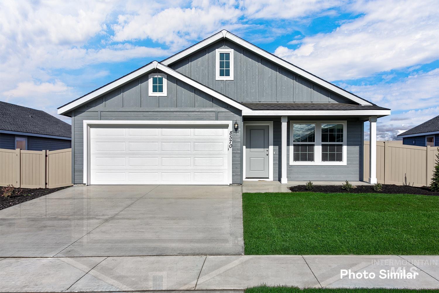 View of front of house with driveway and board and batten siding