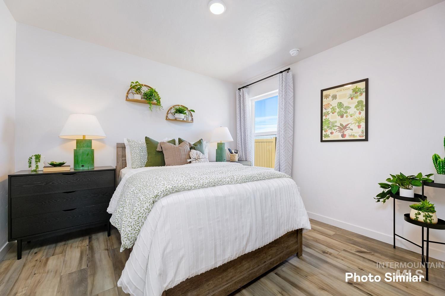 Bedroom with baseboards and light wood-style flooring