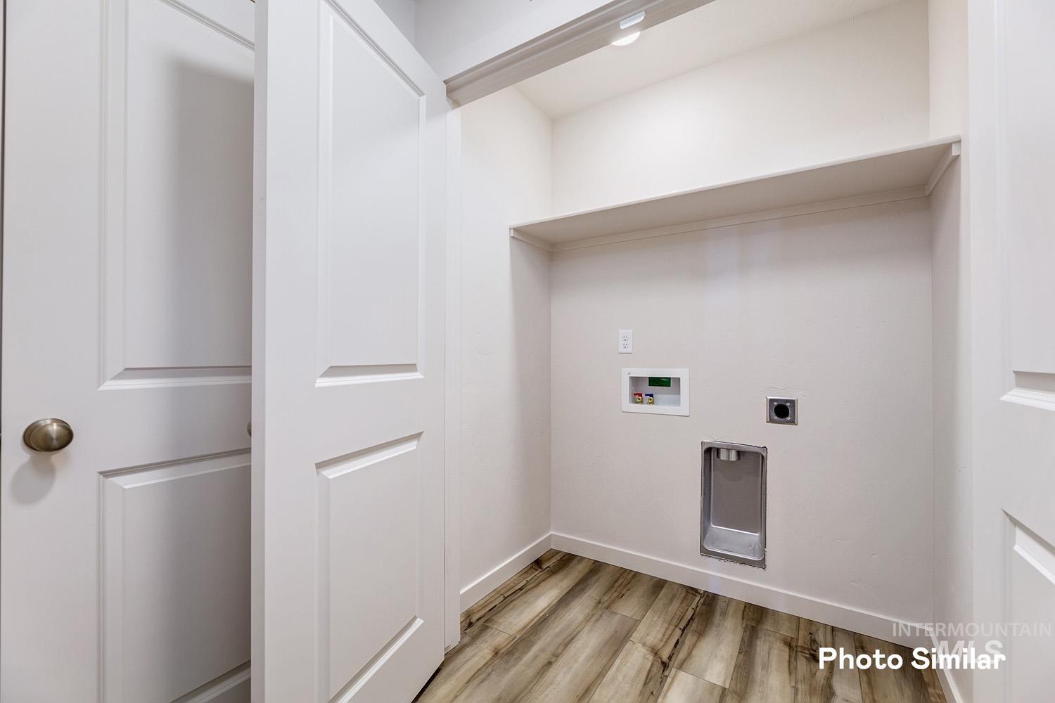 Washroom featuring light wood-style flooring, washer hookup, and hookup for an electric dryer
