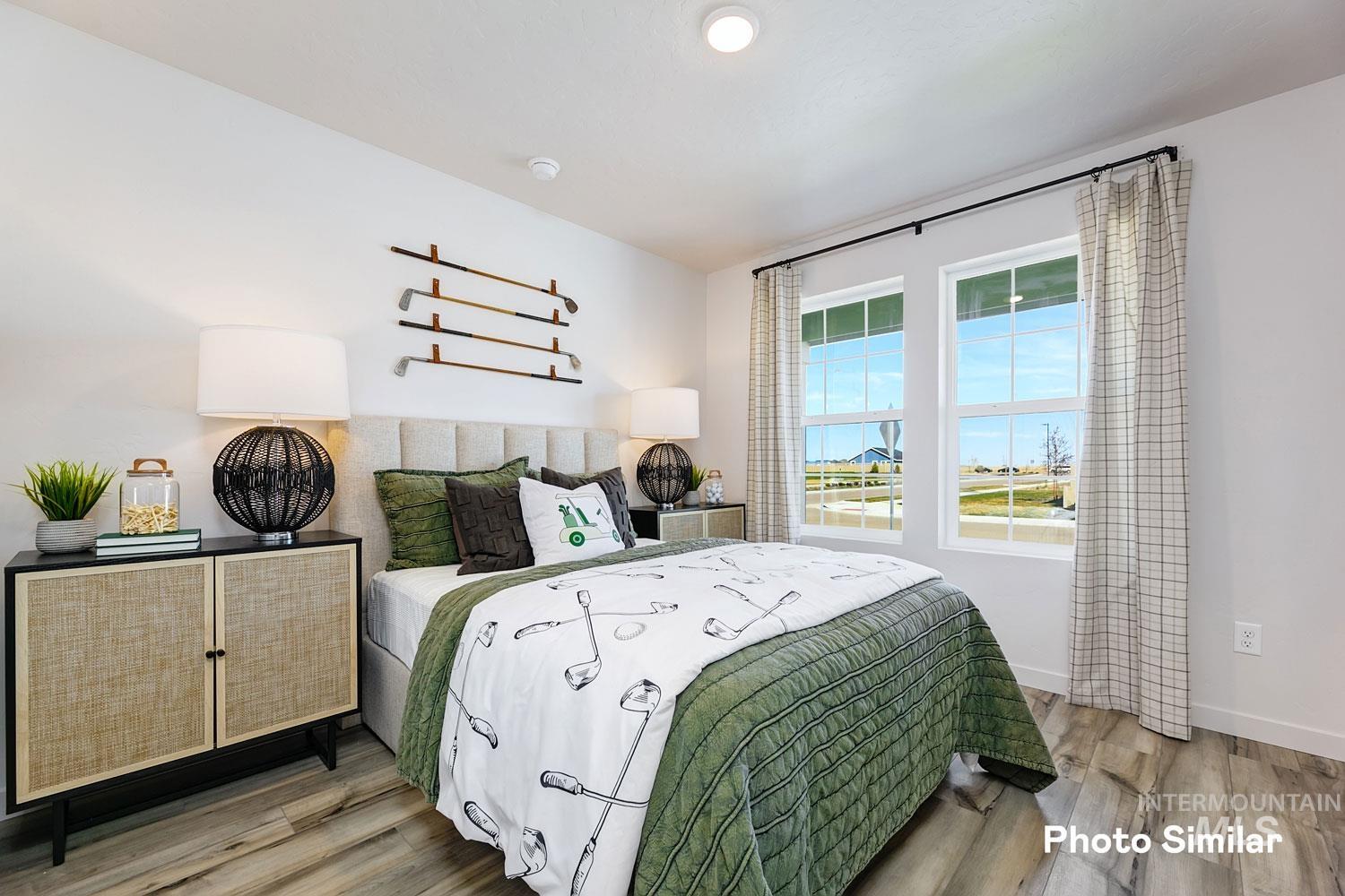 Bedroom with light wood-style floors and baseboards