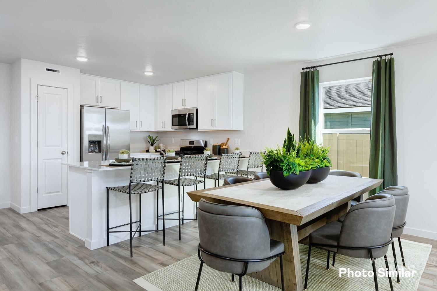 Dining room with light wood-type flooring and recessed lighting