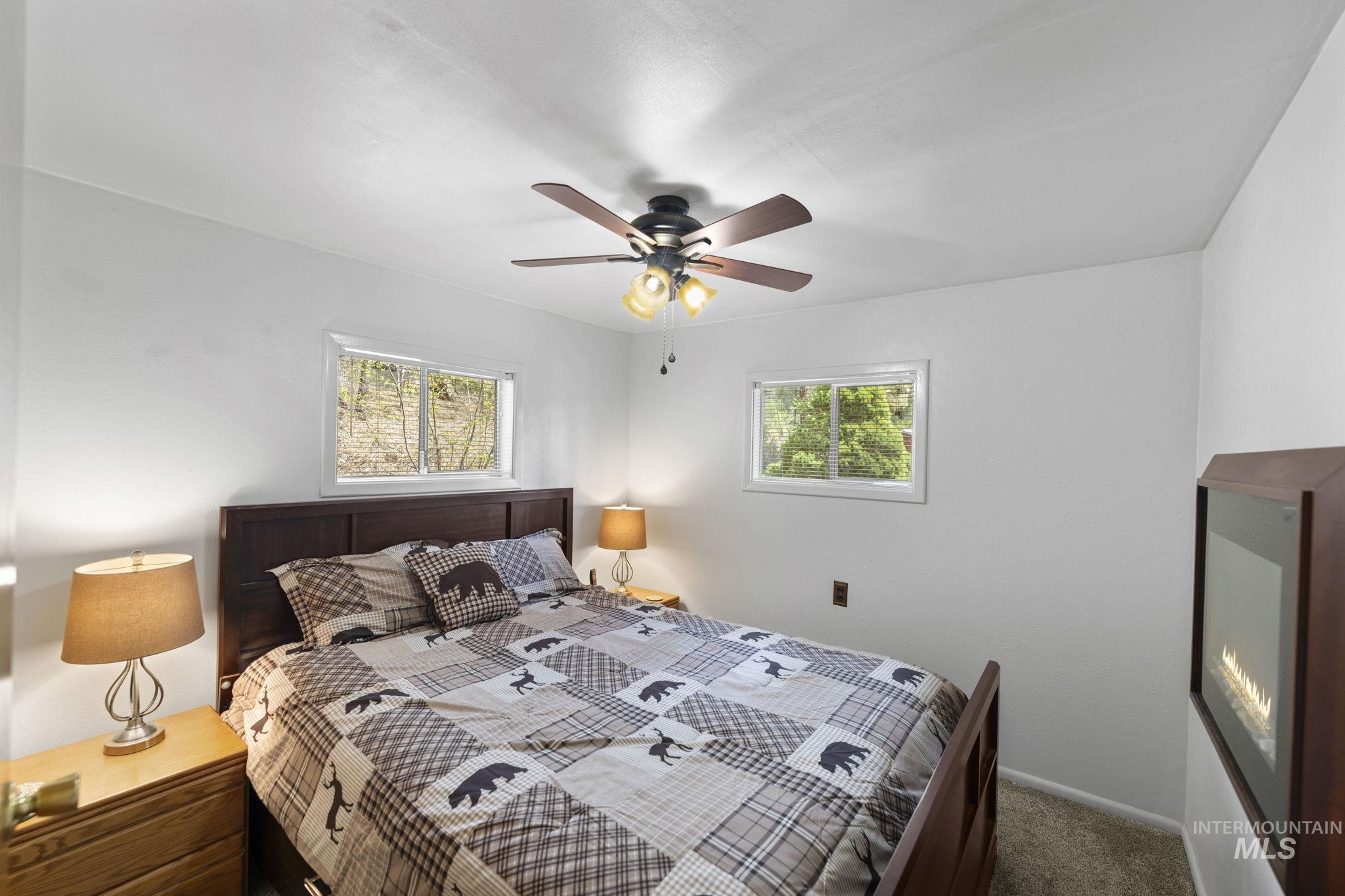 Bedroom with ceiling fan and carpet flooring