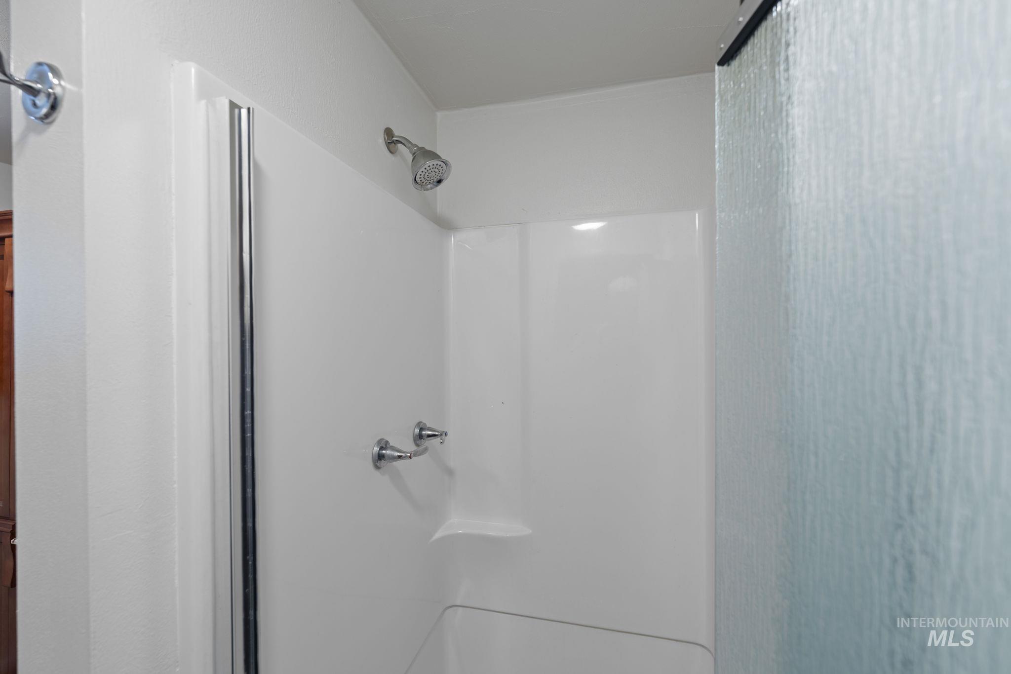 Full bath featuring a shower stall