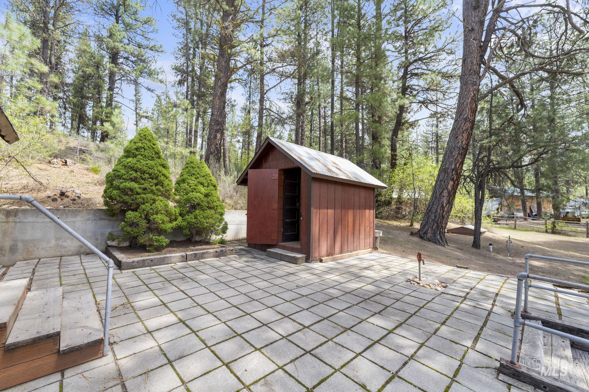 View of patio featuring a storage unit