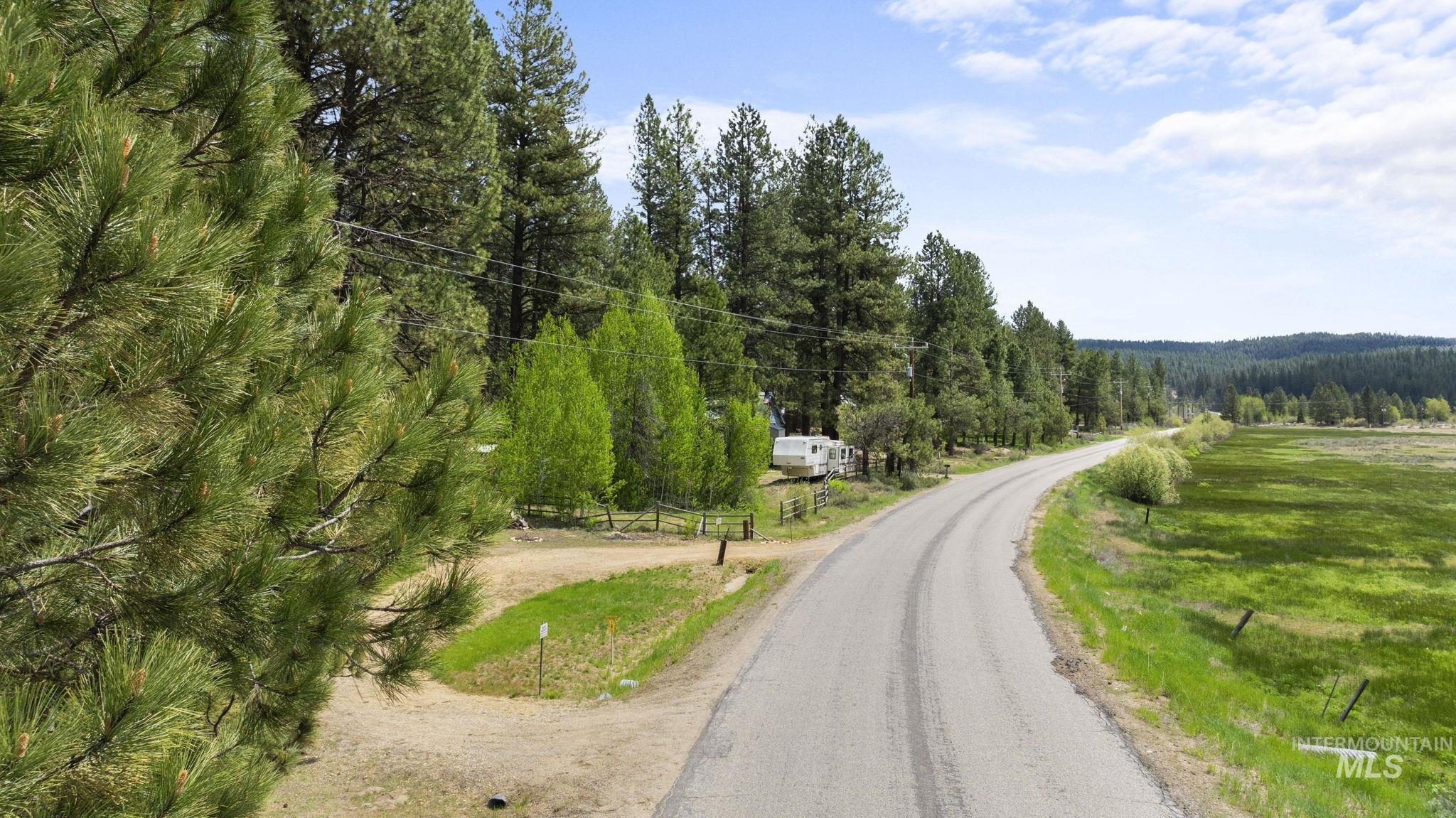 View of asphalt road featuring a forest view