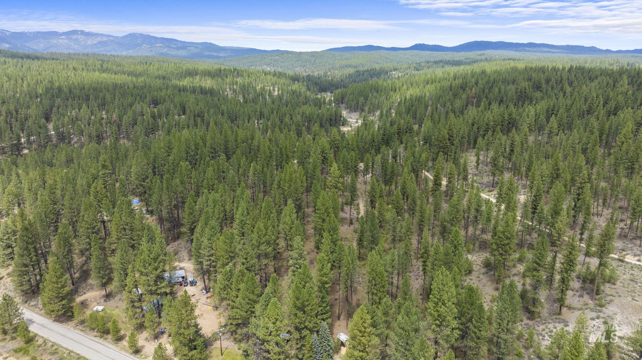 Aerial view of property and surrounding area featuring mountains