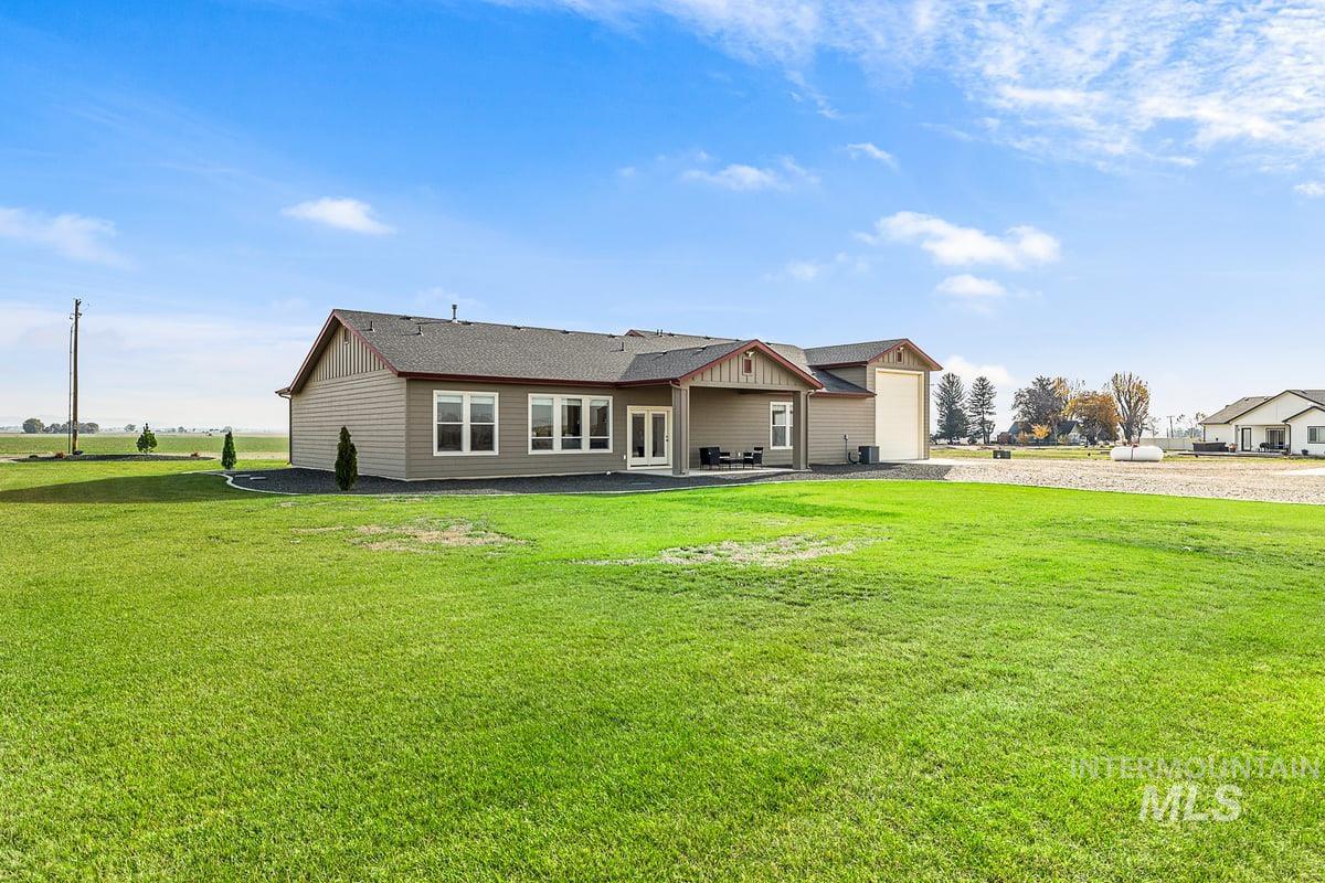 Back of house featuring a lawn and covered patio