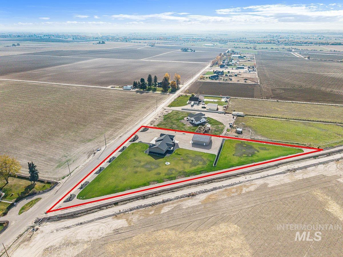 Aerial view of sparsely populated area with property boundaries highlighted and farmland