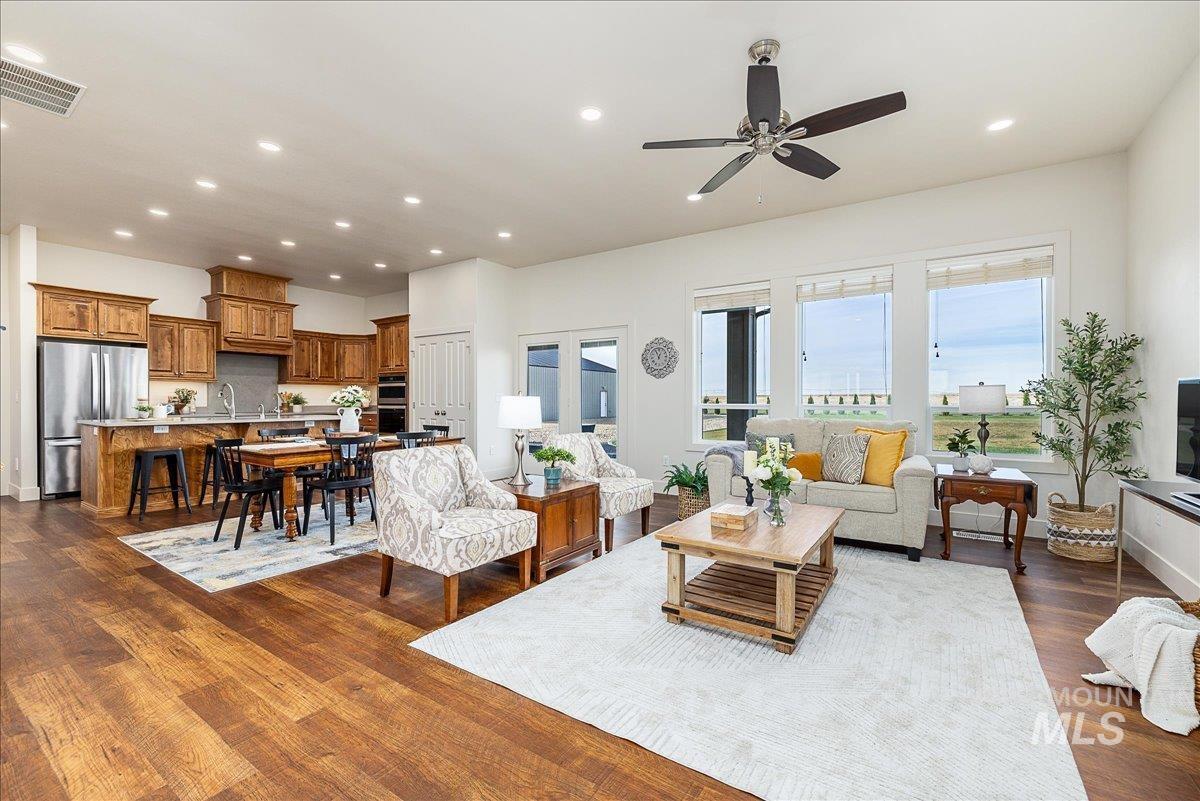 Living area with recessed lighting, dark wood-style floors, and ceiling fan