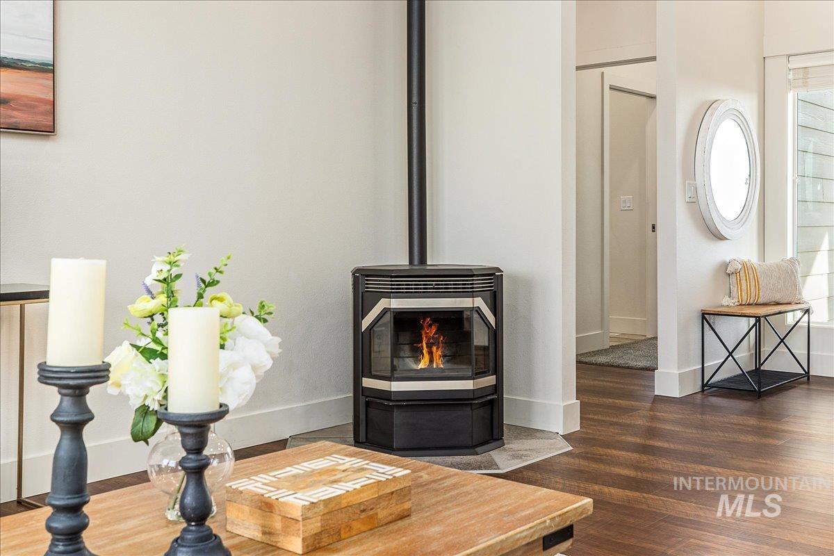Detailed view of wood finished floors and a pellet stove