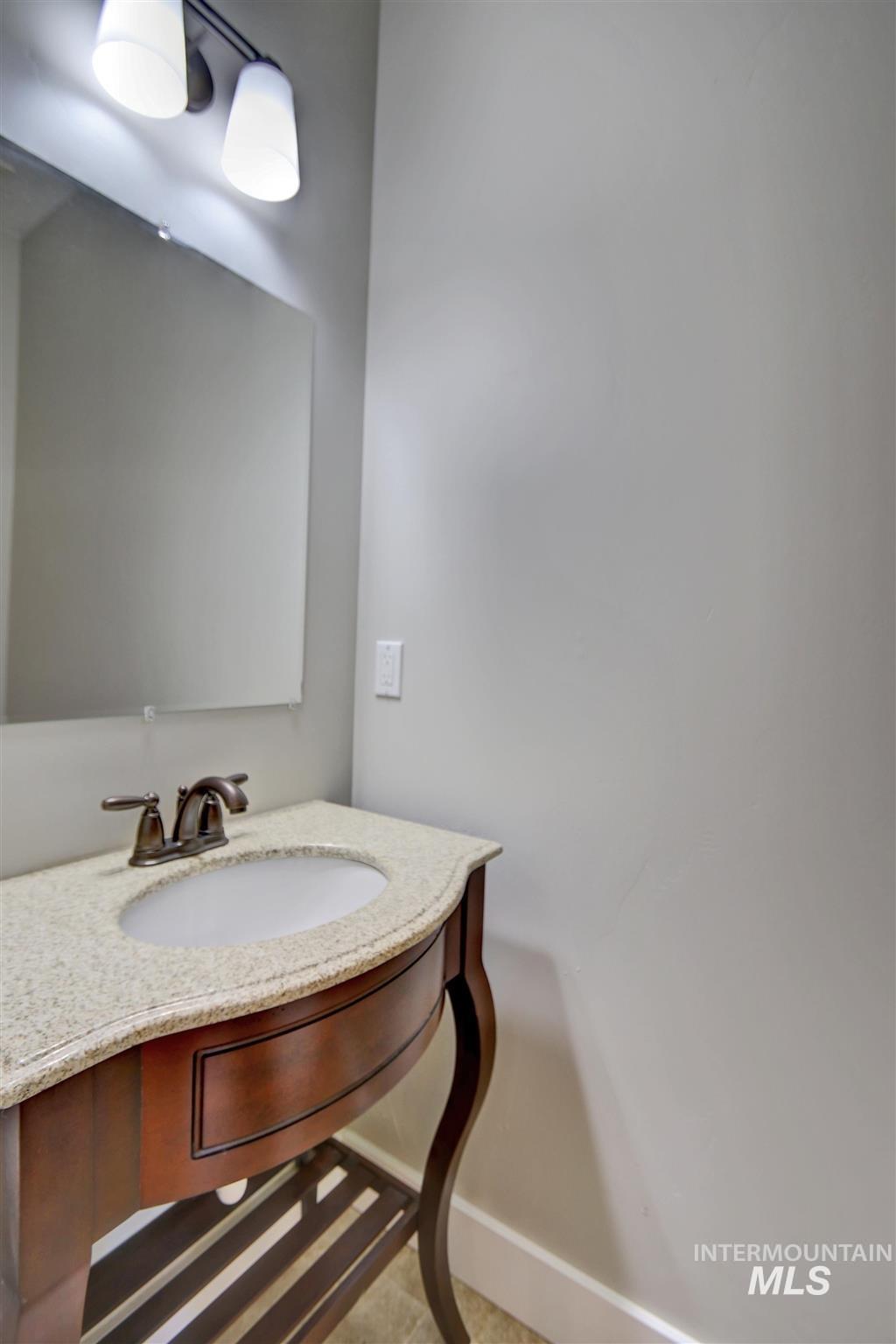 Bathroom with vanity and baseboards