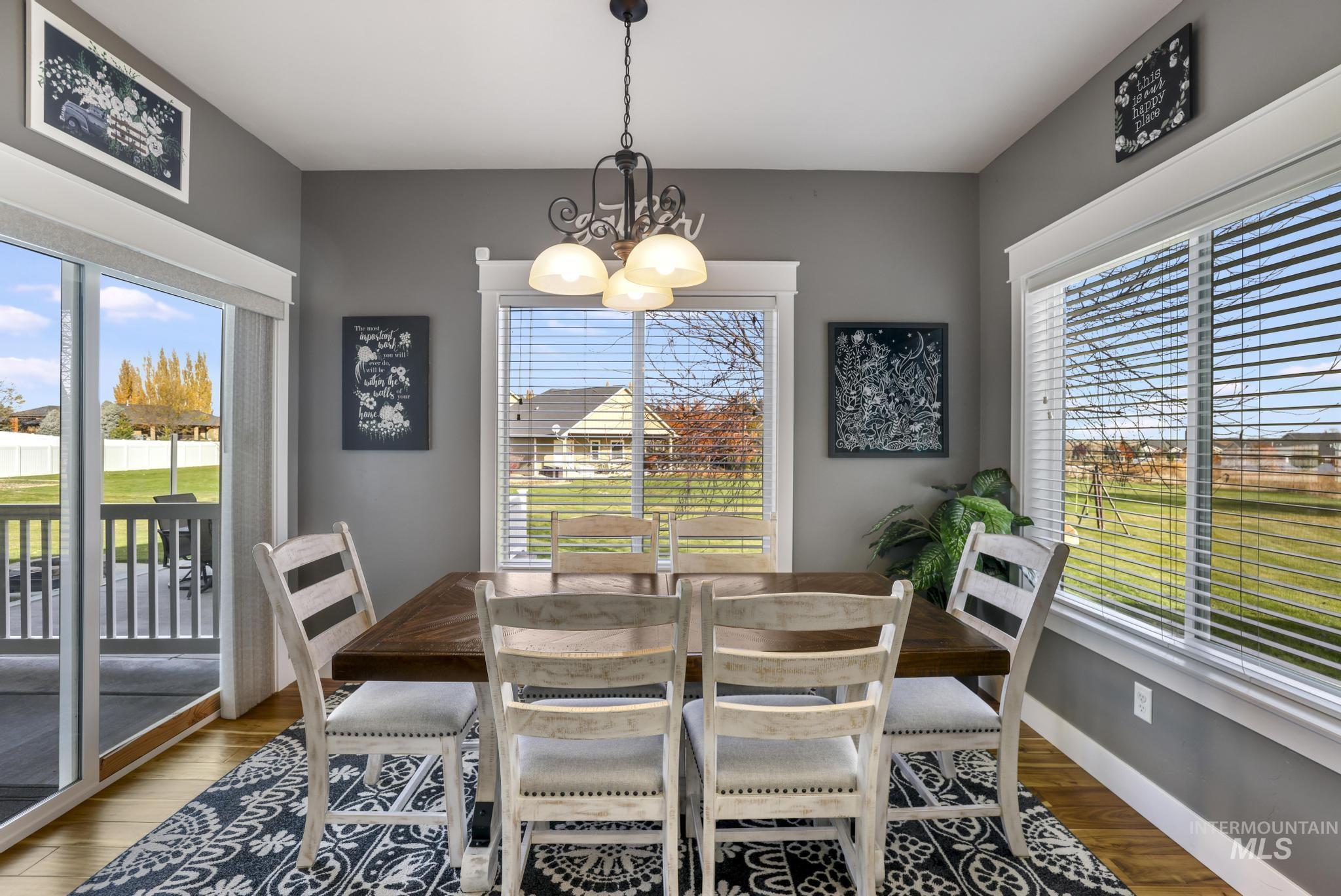 Dining room featuring wood finished floors and a chandelier