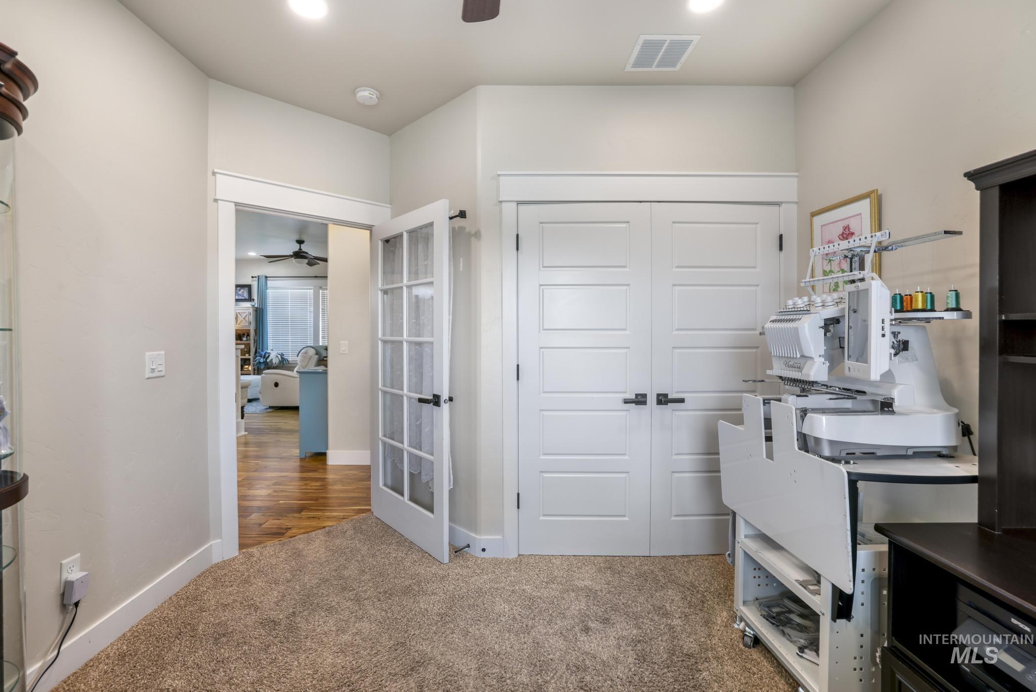 Office featuring light colored carpet, ceiling fan, and recessed lighting