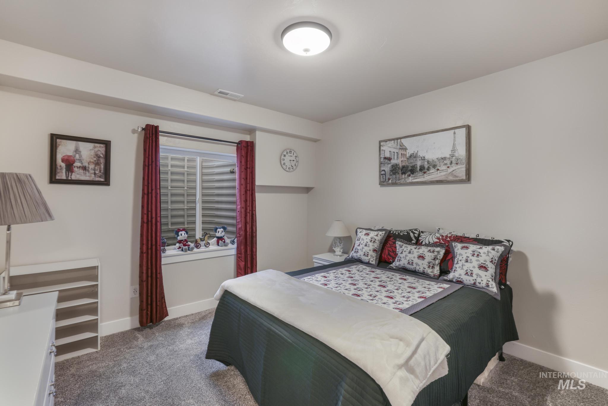 Carpeted bedroom featuring baseboards
